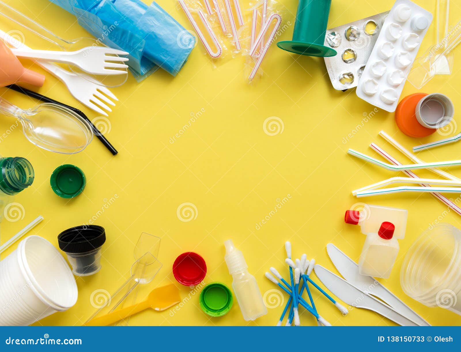 white single-use plastic and other plastic items on a yellow background