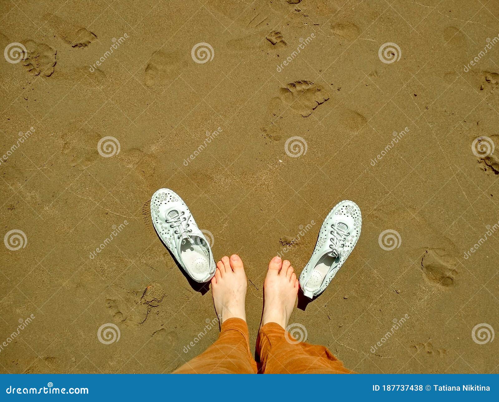 Slippers Next To Barefooted Feet on the Wet Yellow Sand. Stock - Image of flatfoot, pretty: 187737438