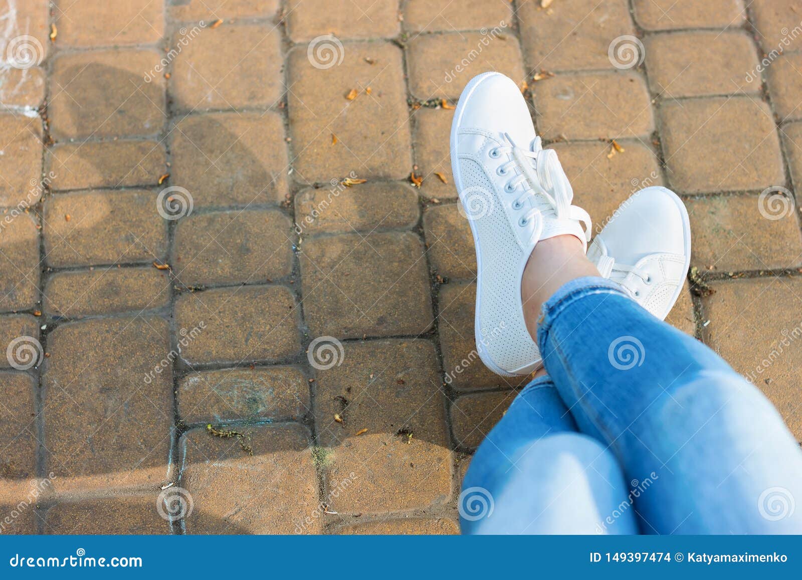 White Sneakers on Girl Legs in Blue Jeans Stock Photo - Image of ...