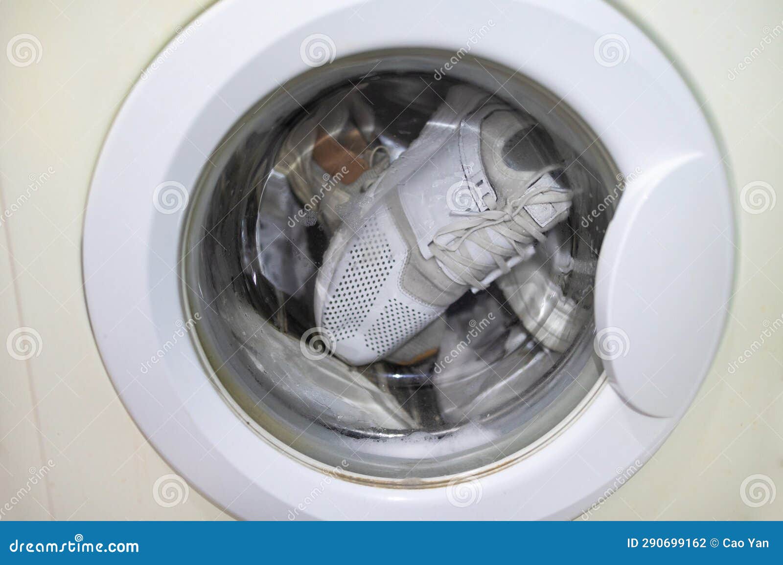 White Sneakers in Laundry Machine. Washing Machine in the Process Stock ...