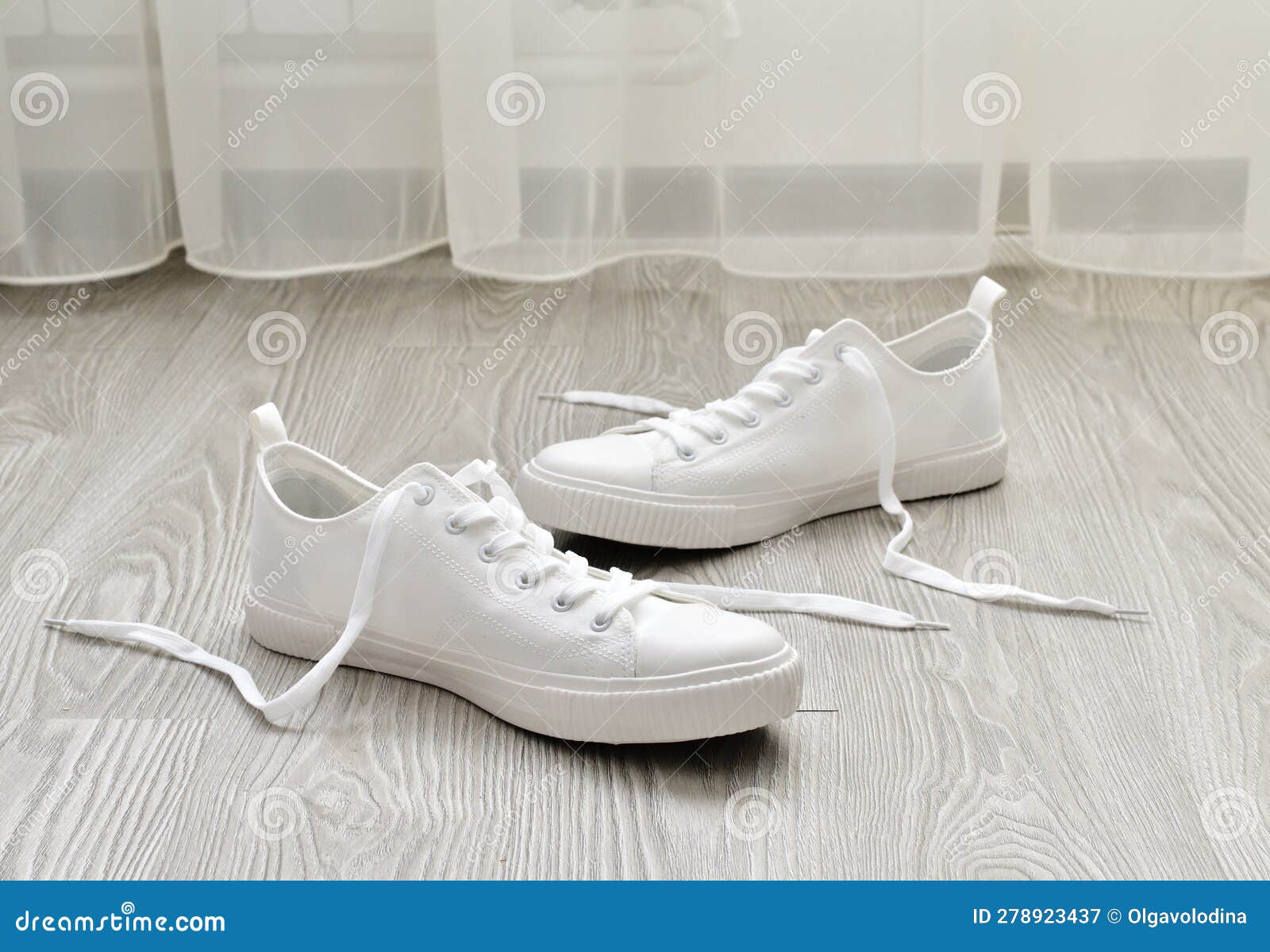 White Sneakers with Untied Laces are on Floor Stock Image Image of