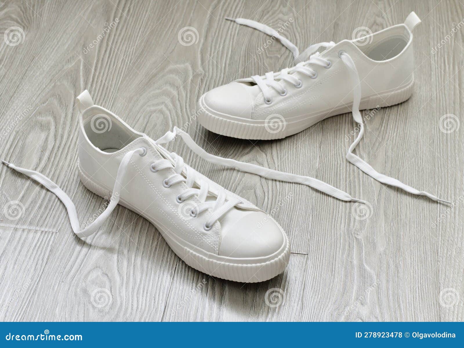 White Sneakers with Untied Laces are on Floor Stock Photo Image of