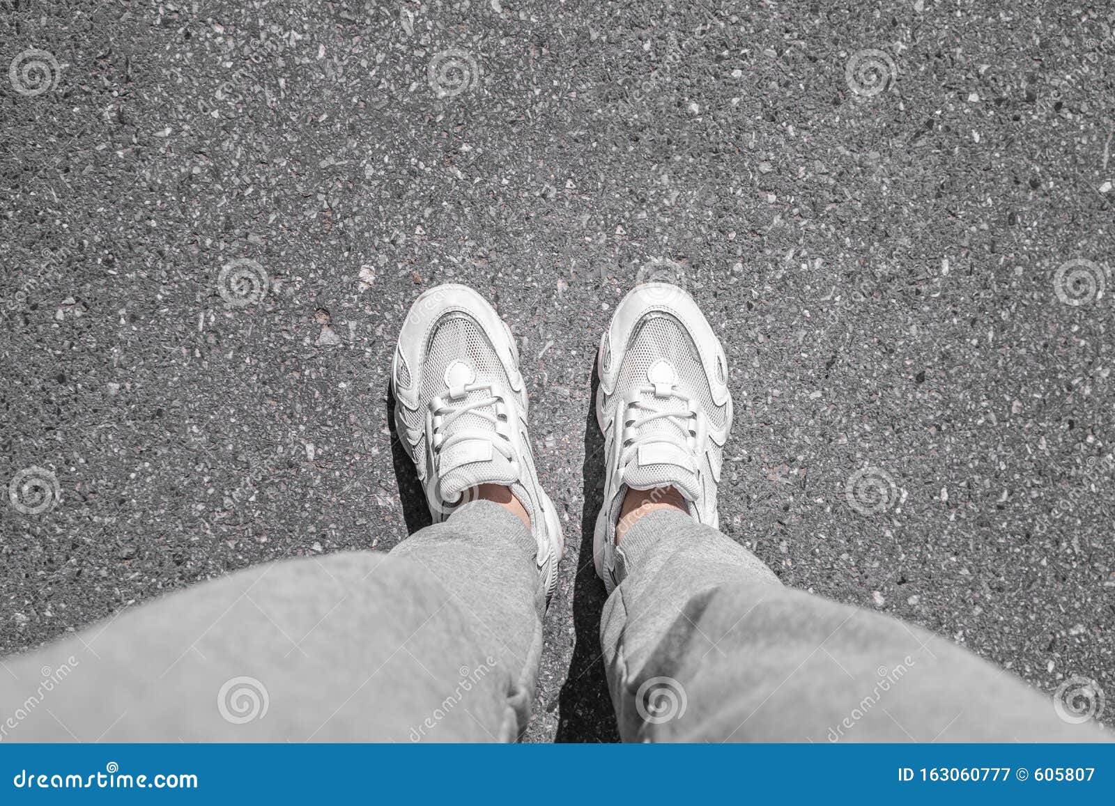 White Sneakers Walking on Concrete. Sneakers on the Pavement. Top View ...