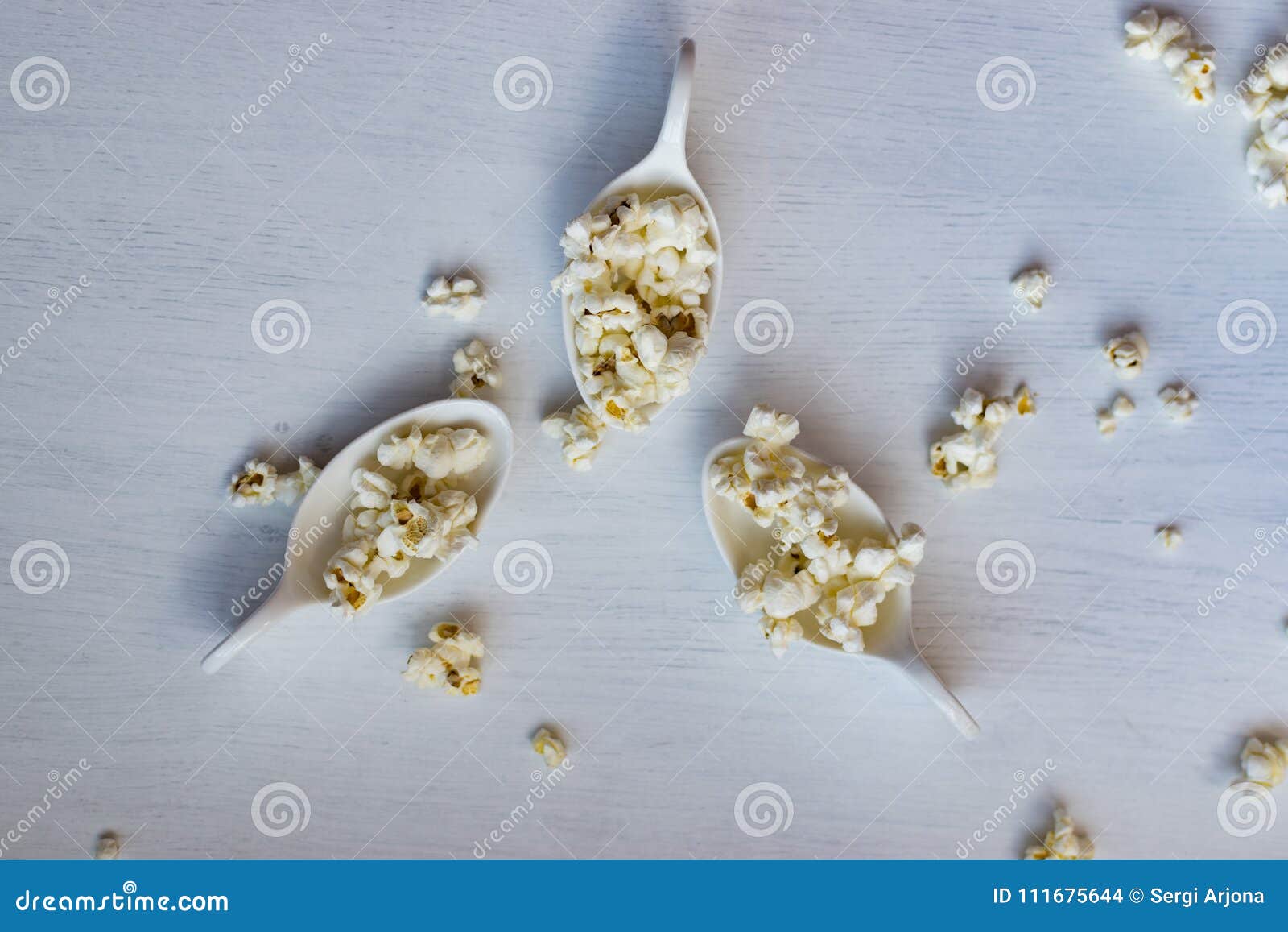 white spoon with popcorn.