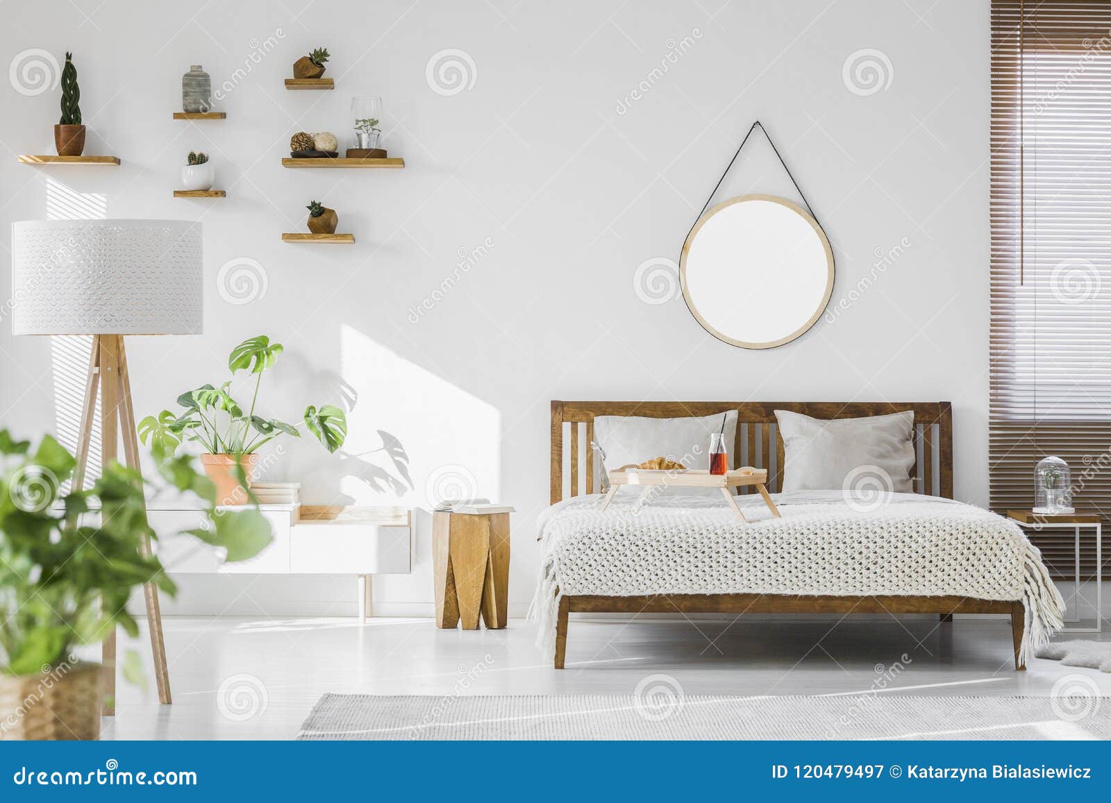 a white, sunlit hotel bedroom interior with monstera deliciosa p