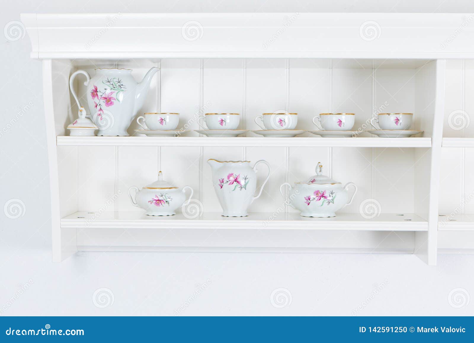 White Tea Shelf with Mugs.Tea Dish on the White Wall Stock Photo