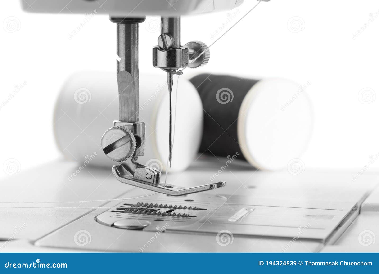 White Thread through the Needle Eye.the Side of the Sewing Machine