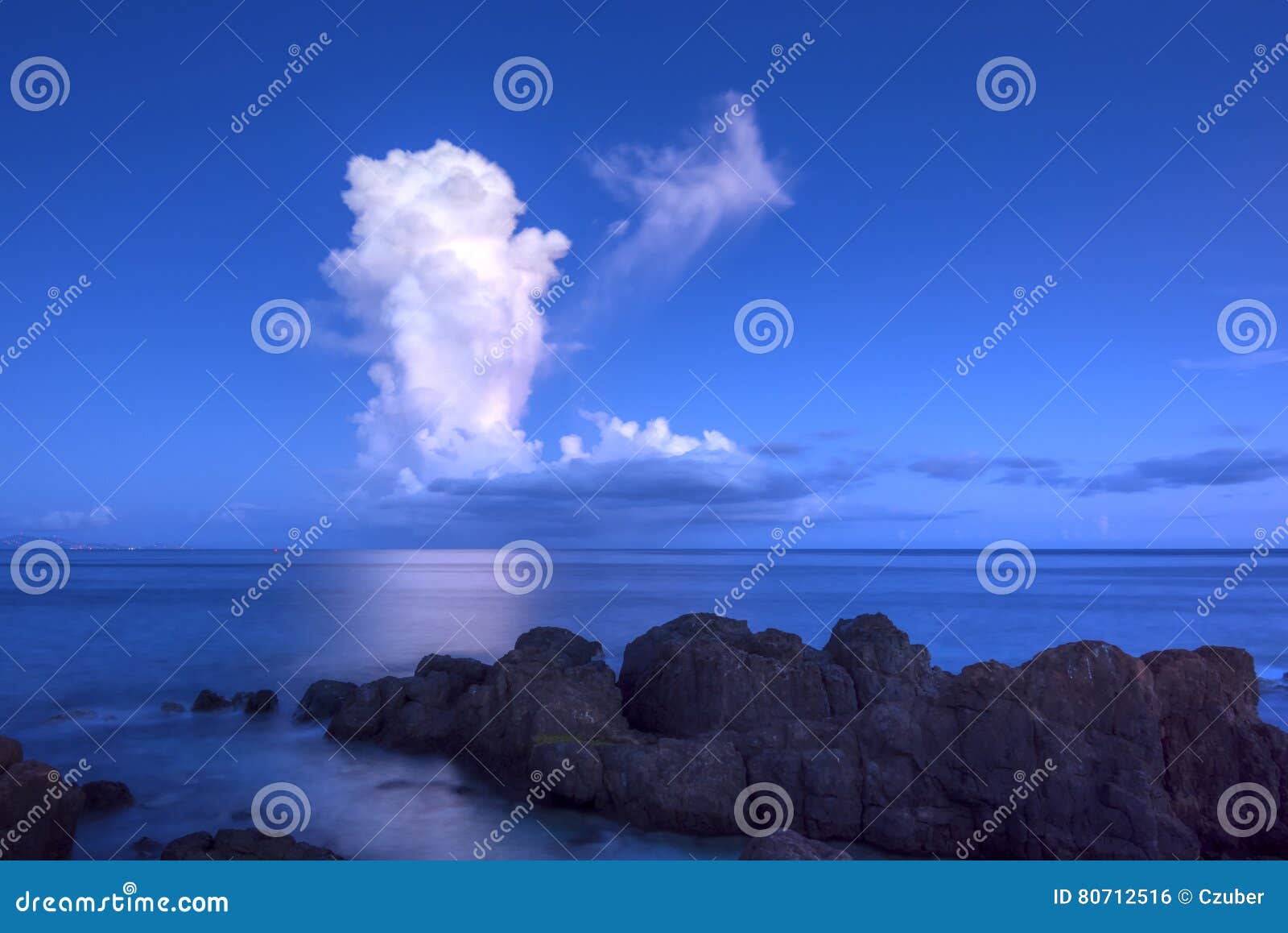 white thunderhead cloud over calm sea