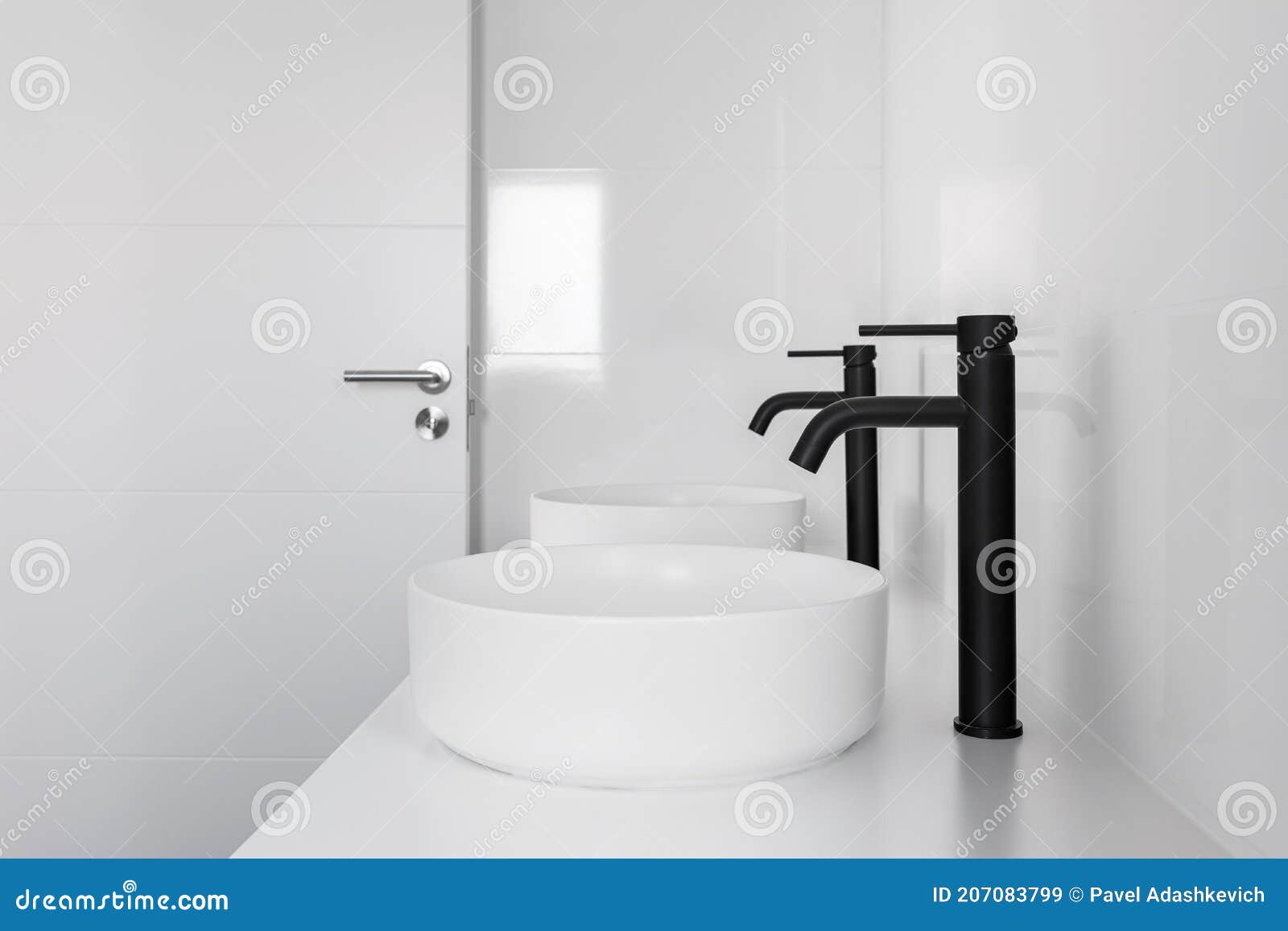 White Tiled Bathroom with Two Wash Basins and Black Faucets Stock Image