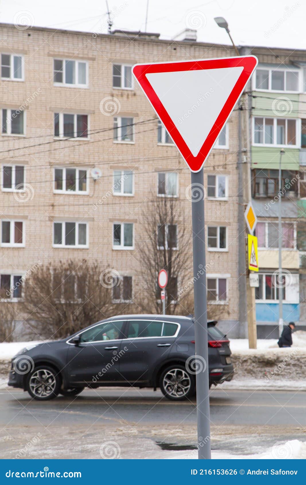 A White Triangle Sign With A Red Outline Means Give Way Stock Photo