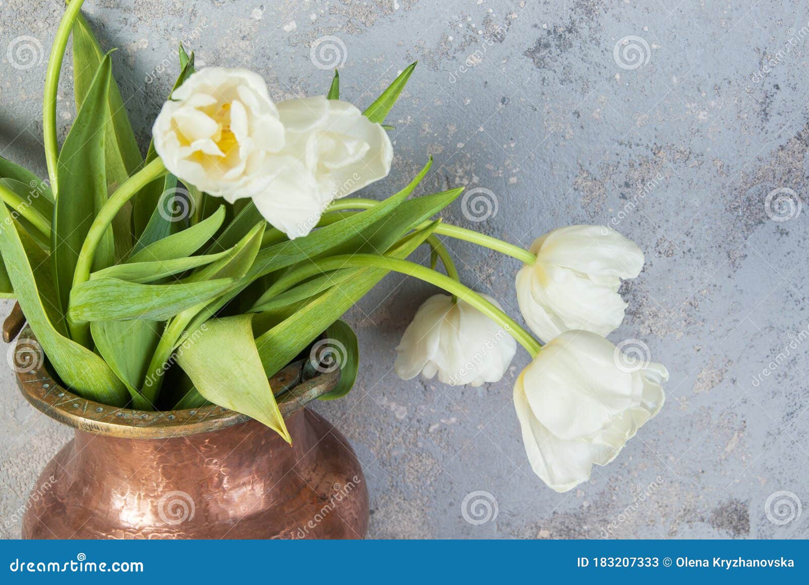 white tulips in old copper vase