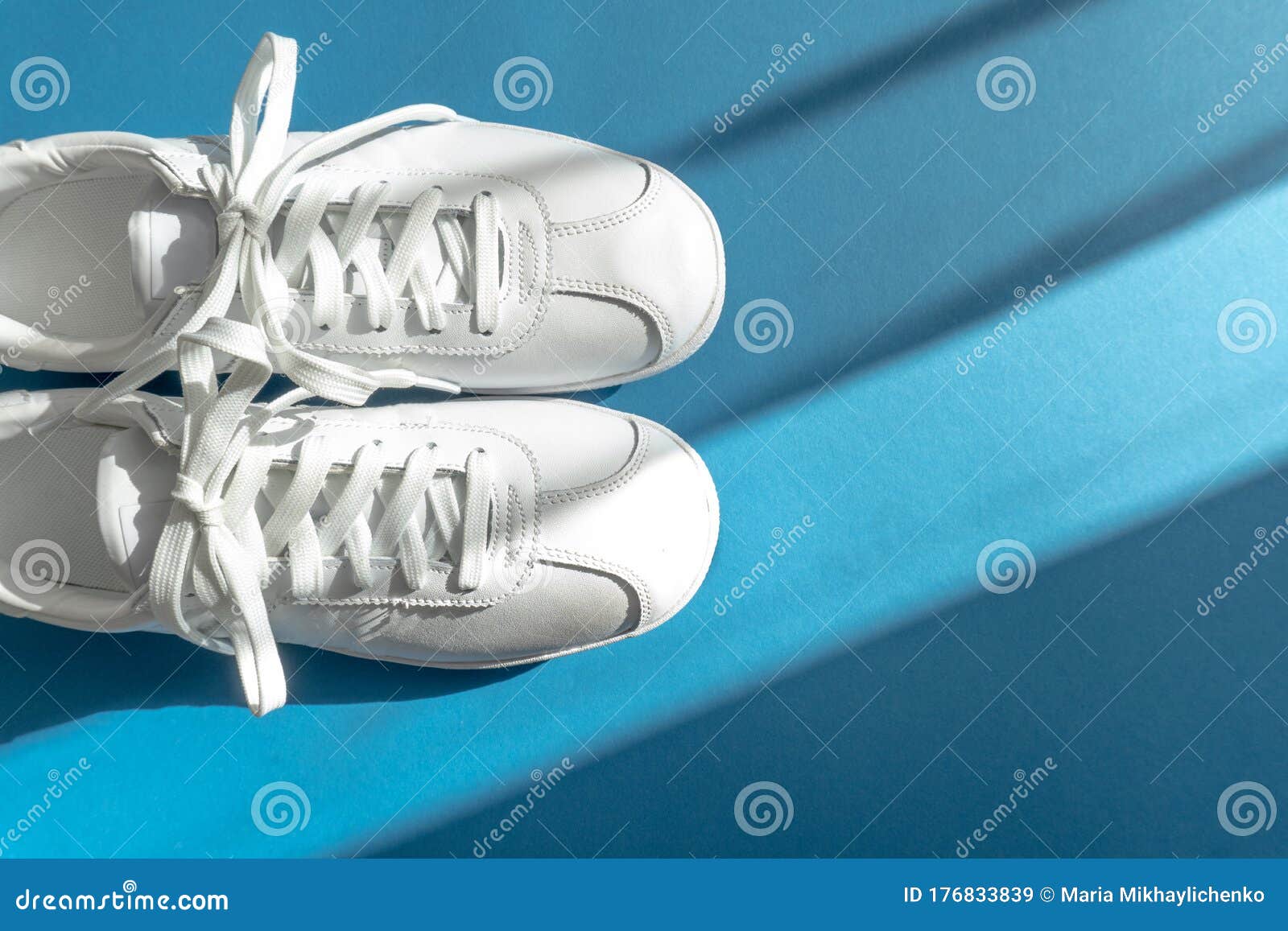 White Unisex Shoes Sneakers on Classic Blue Background Stock Image ...