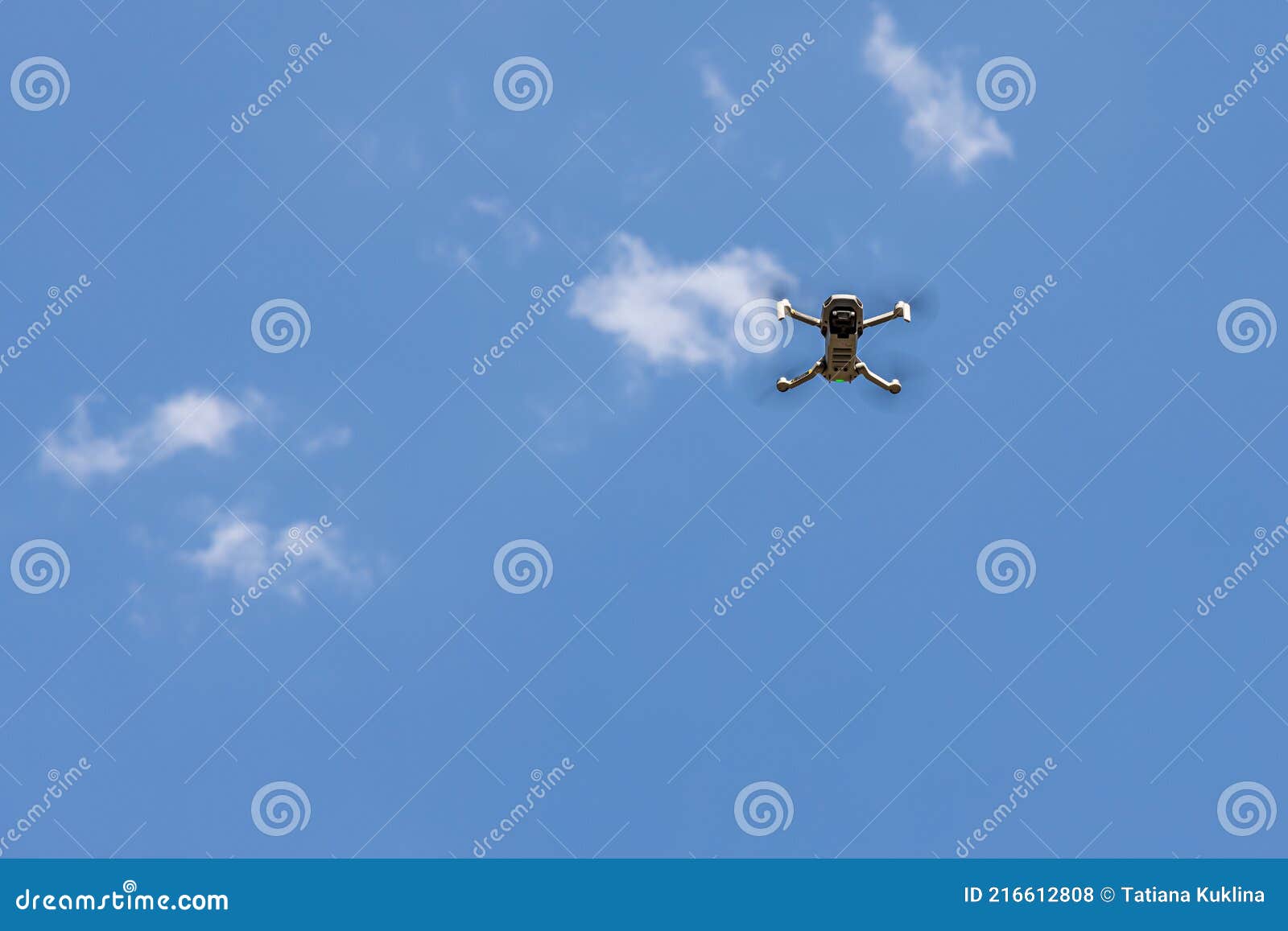 White Unmanned Aerial Vehicle with Four Propellers and Blades is on the