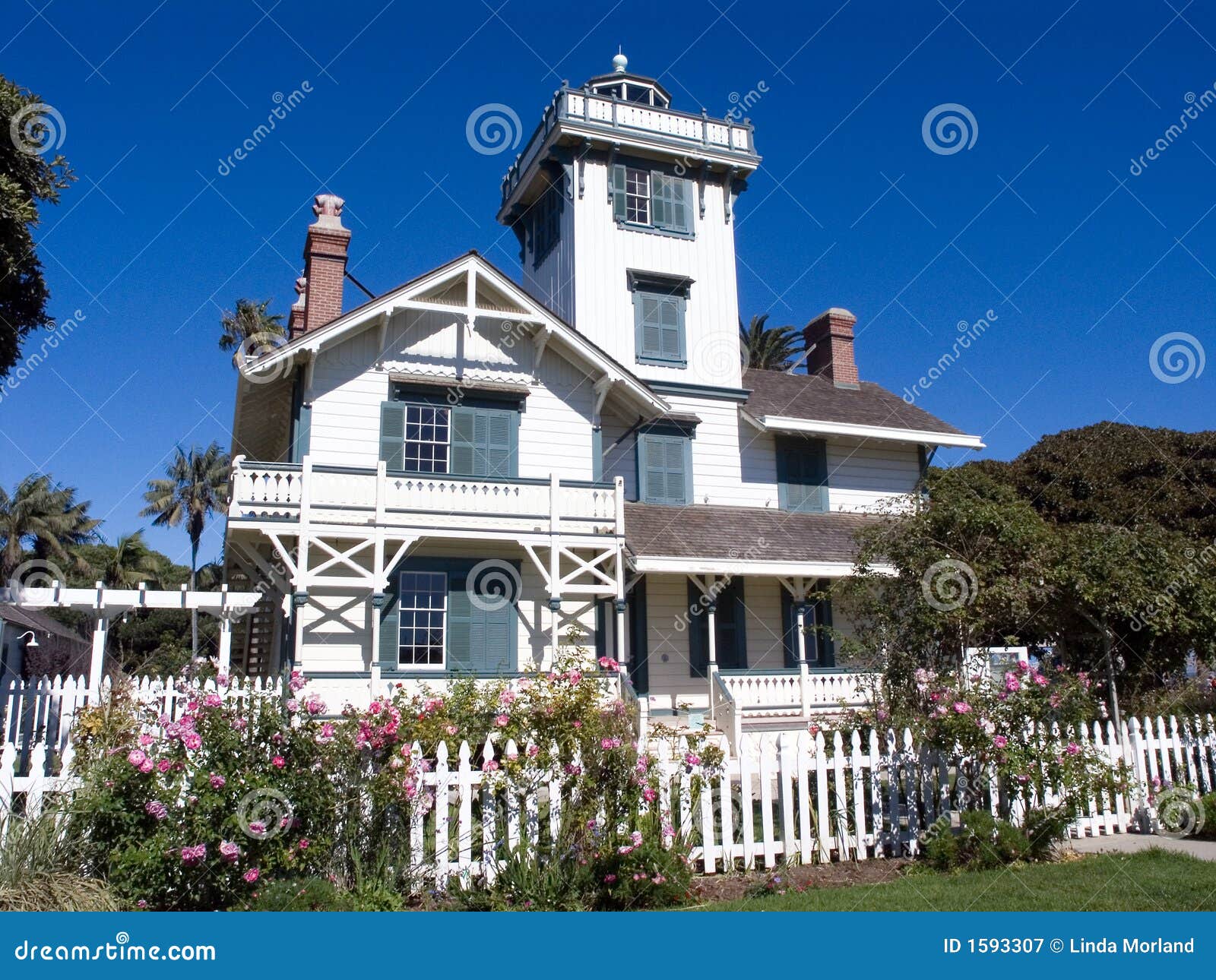 white victorian house with picket fence stock image