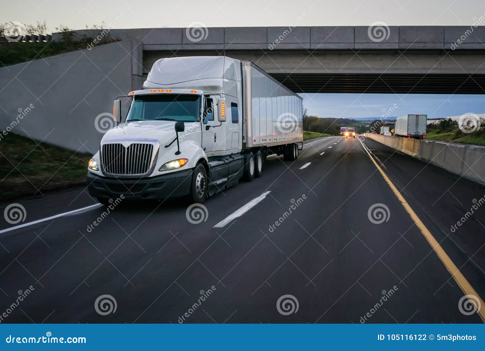white 18 wheeler semi truck and overpass