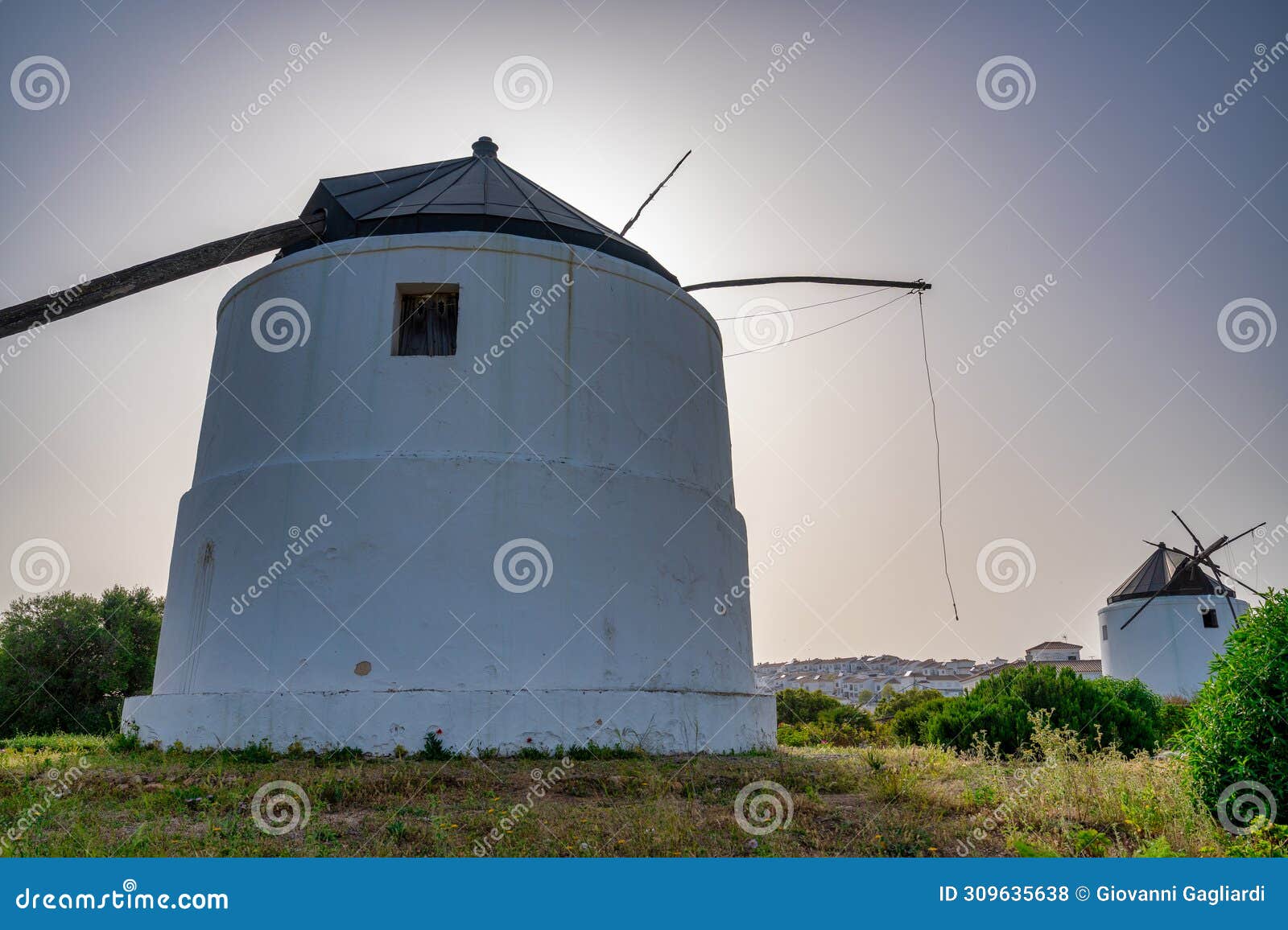 white windmills in vejer de la frontera, andalusia
