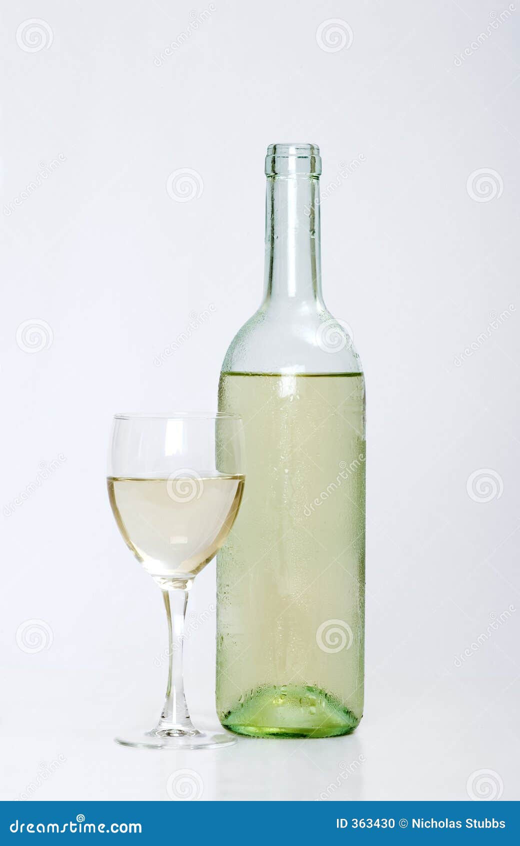 white wine bottle with half filled glass