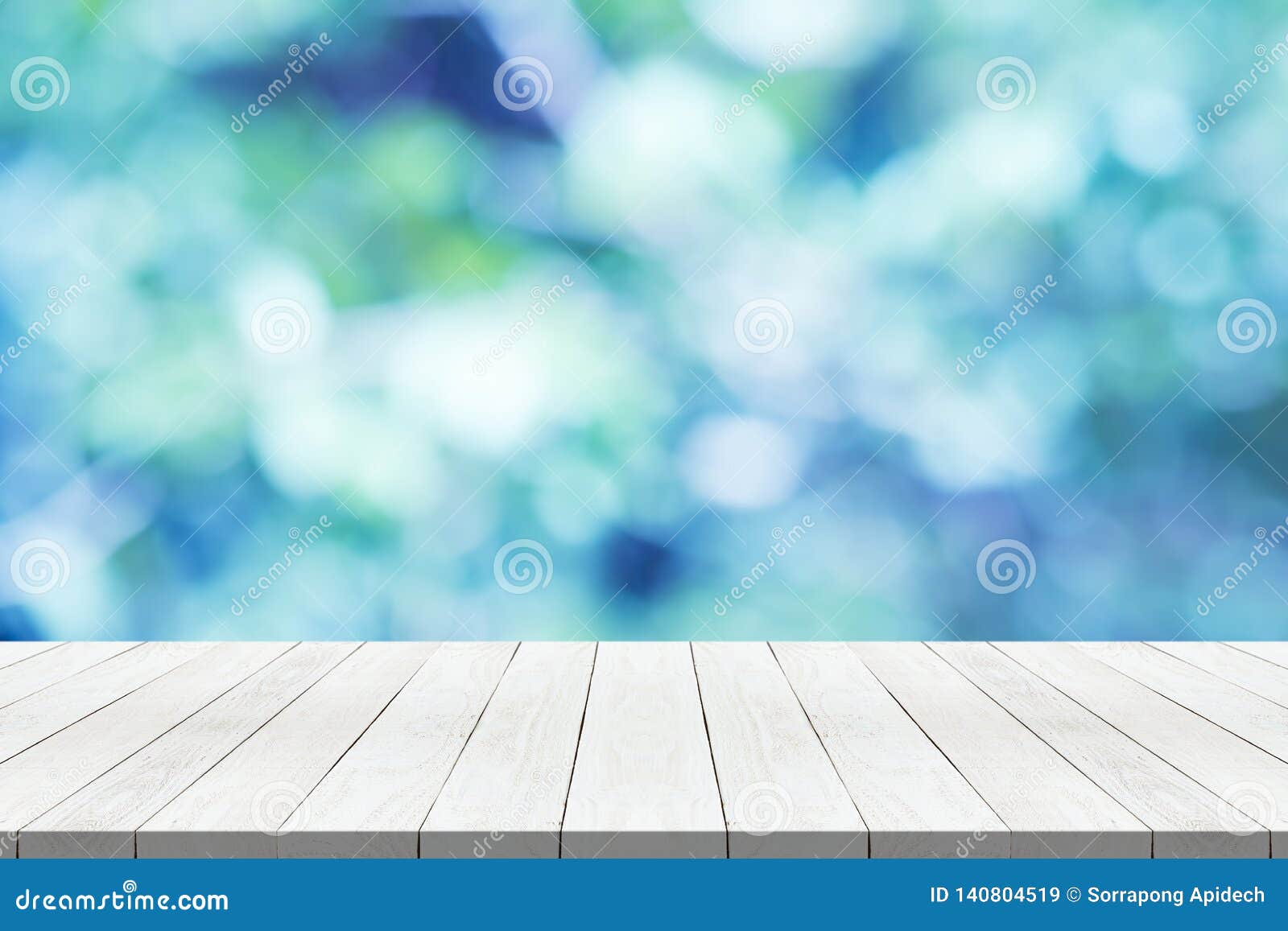wood table top on nature blue blurred background for montage your product
