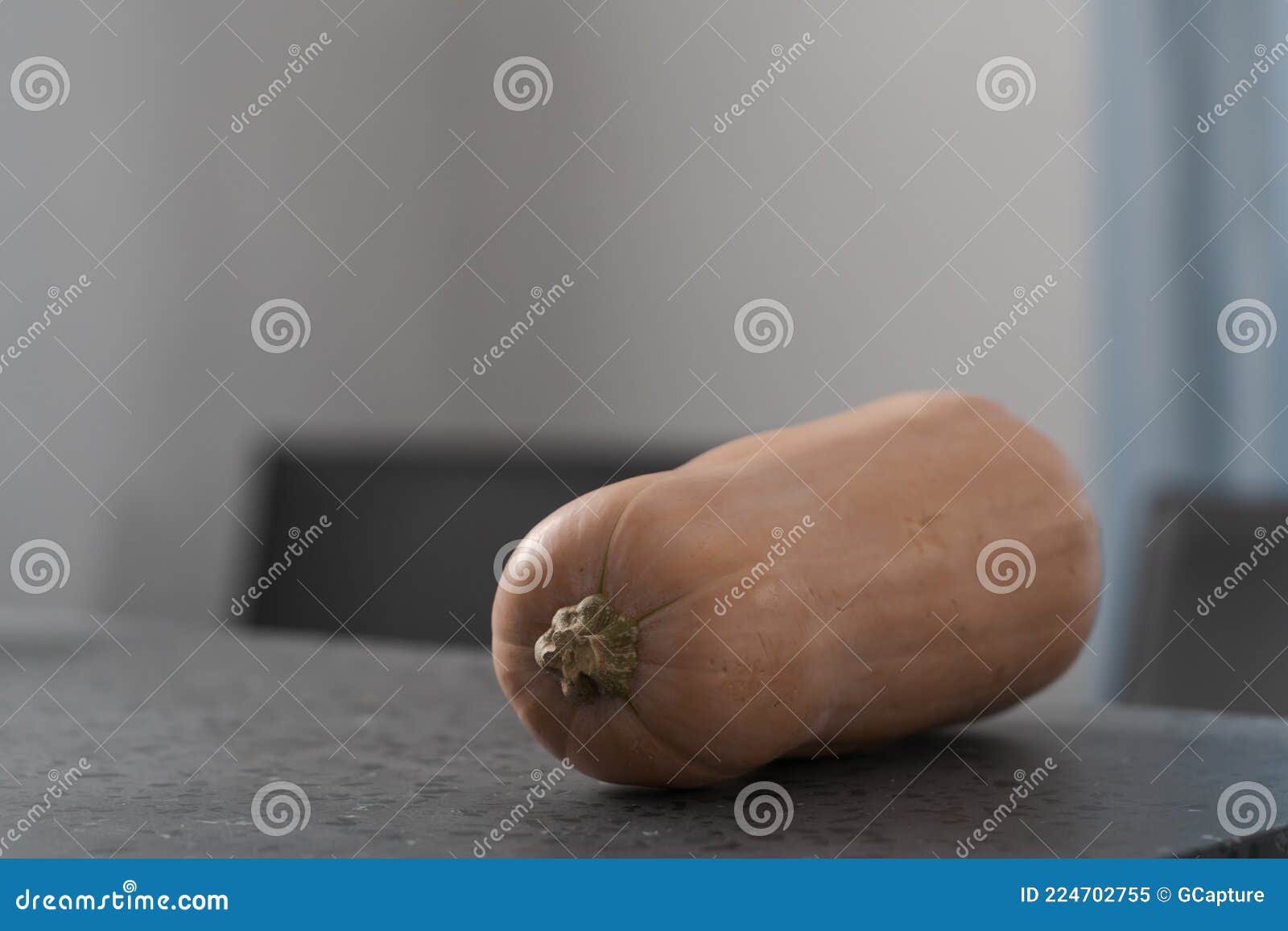 whole butternut squah on concrete countertop