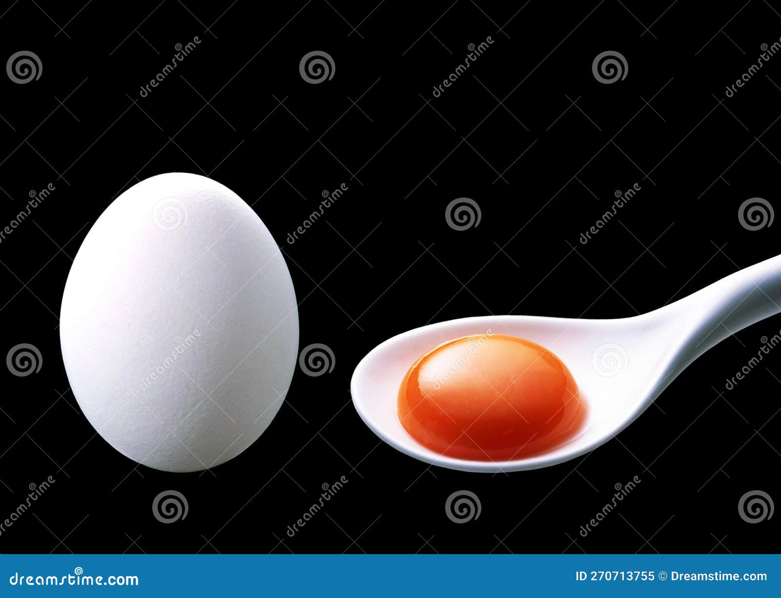 Whole Duck Egg and Egg Yolk on White Spoon, Isolated on Black