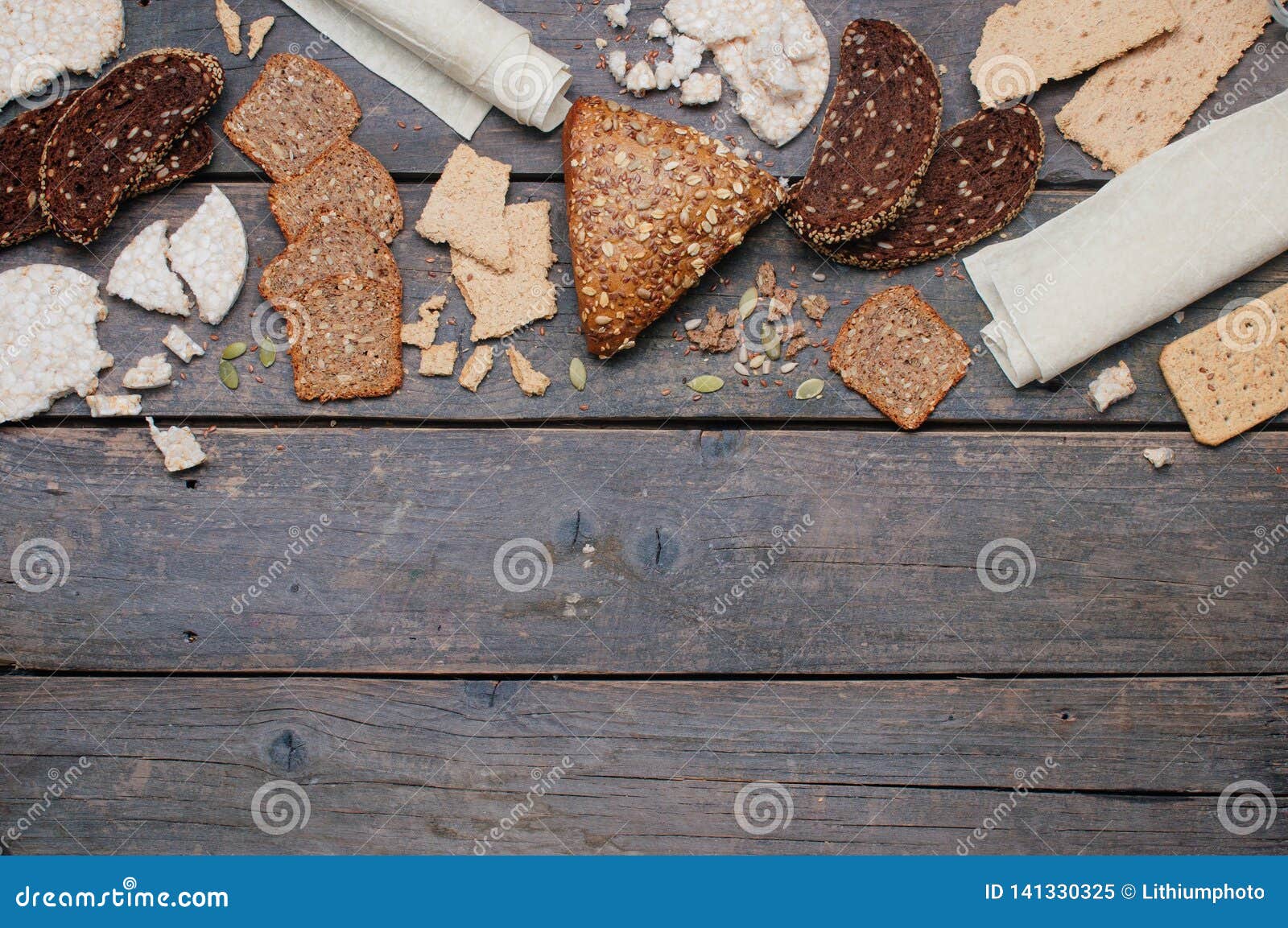 whole grain bread and crispbreads on wooden background