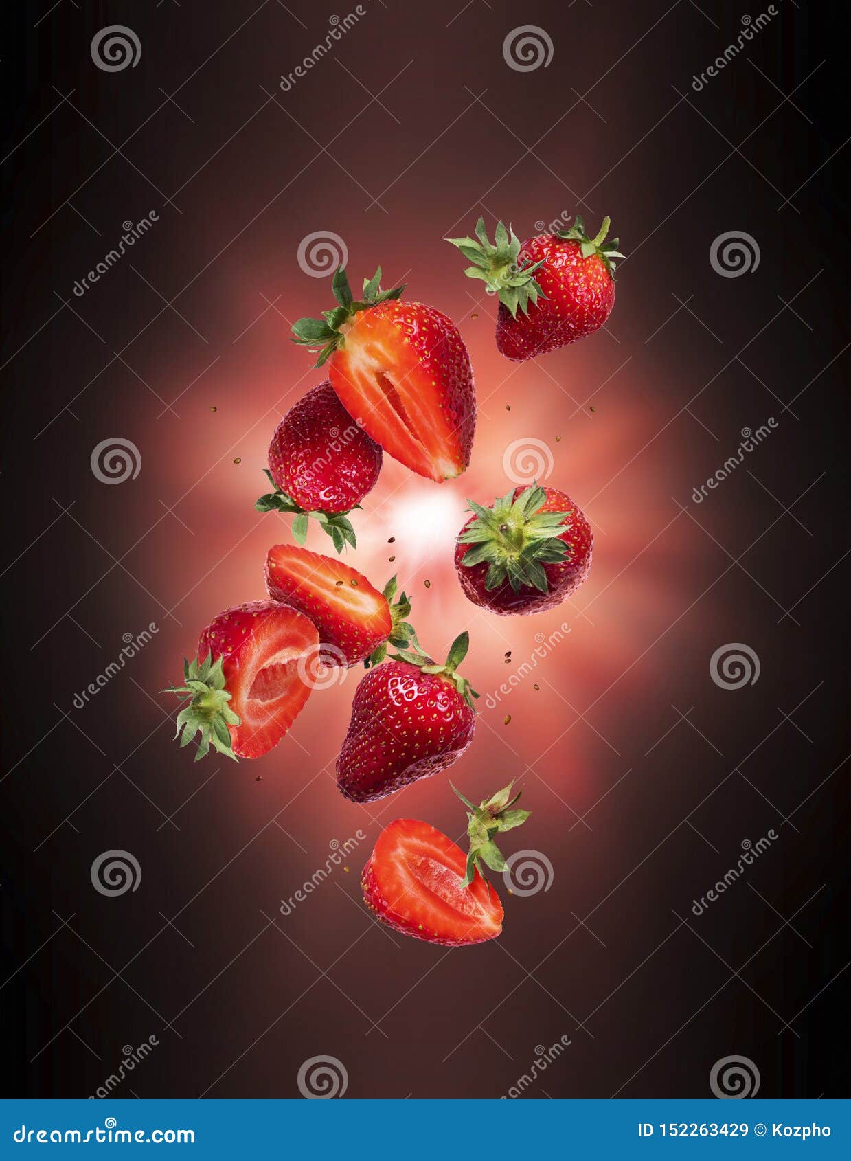 Whole and Sliced Fresh Strawberries in the Air with Flash of Light in
