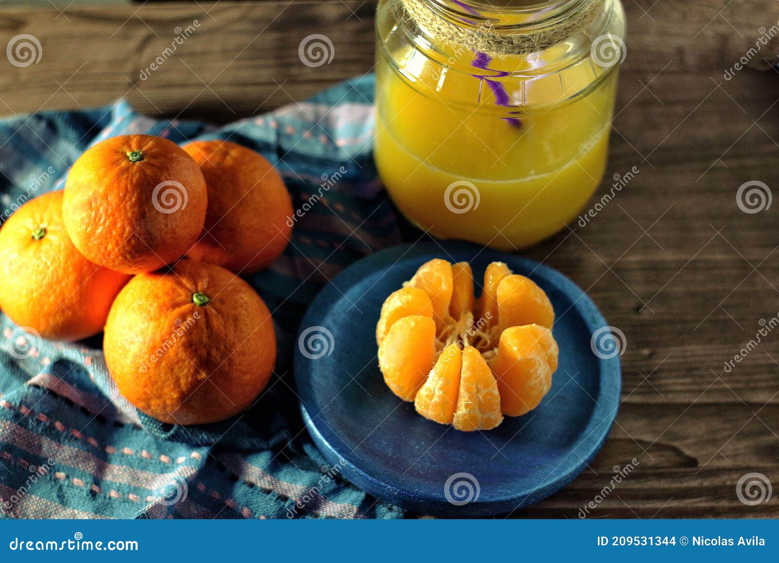 mandarins and glass jar with juice