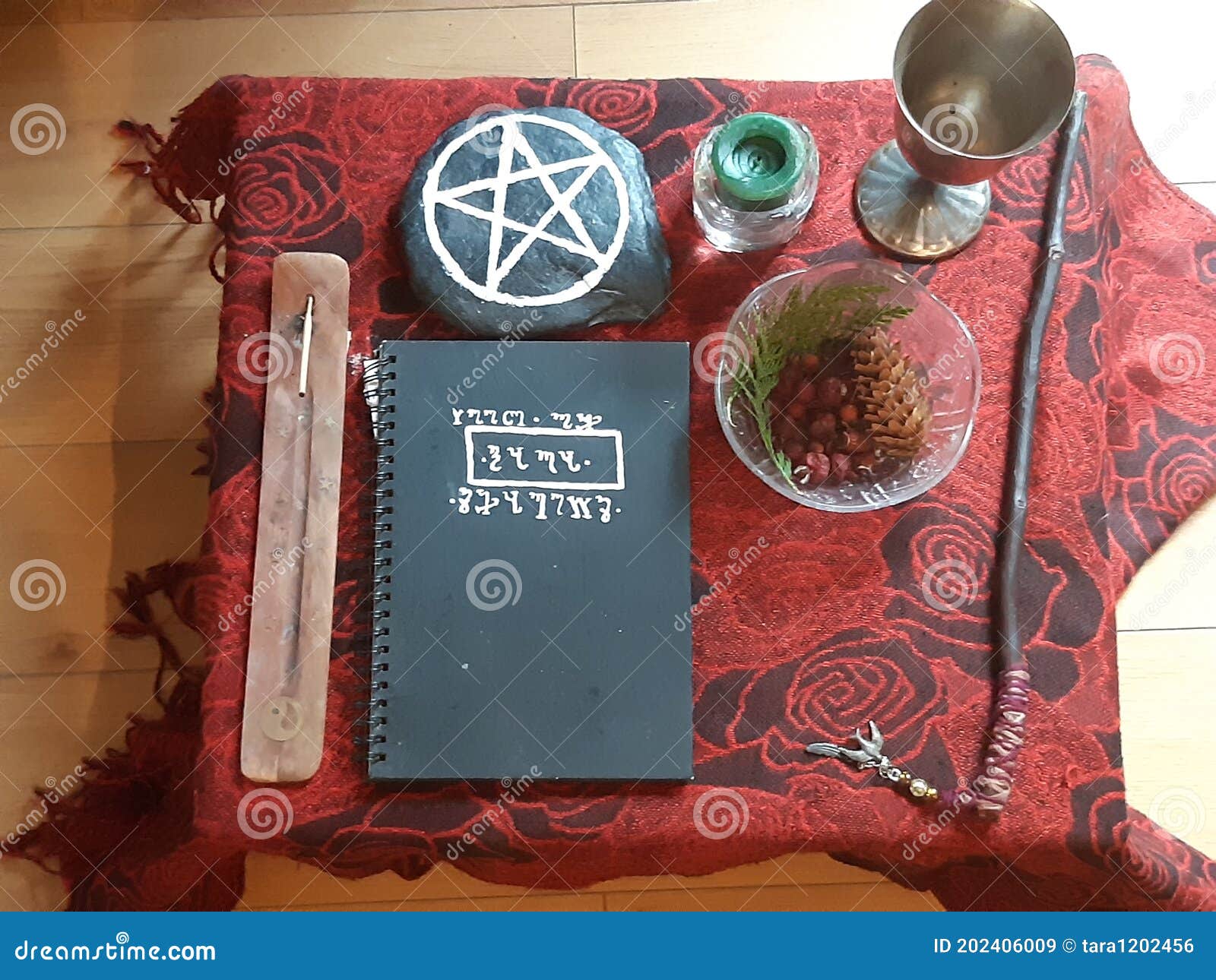 wiccan altar, fall altar setup, pagan magic ritual altar . book of shadows, wand, incense and candles
