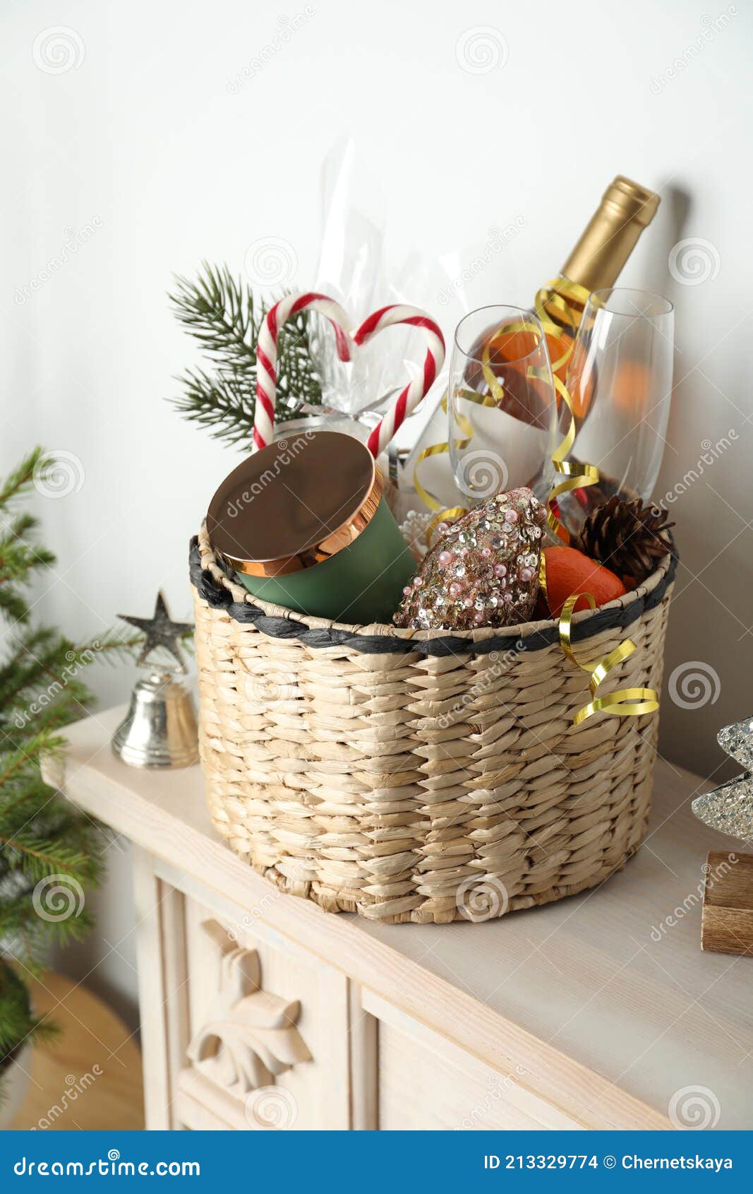 Wicker Basket with Gift Set and Christmas Decor on Shelf Stock Photo