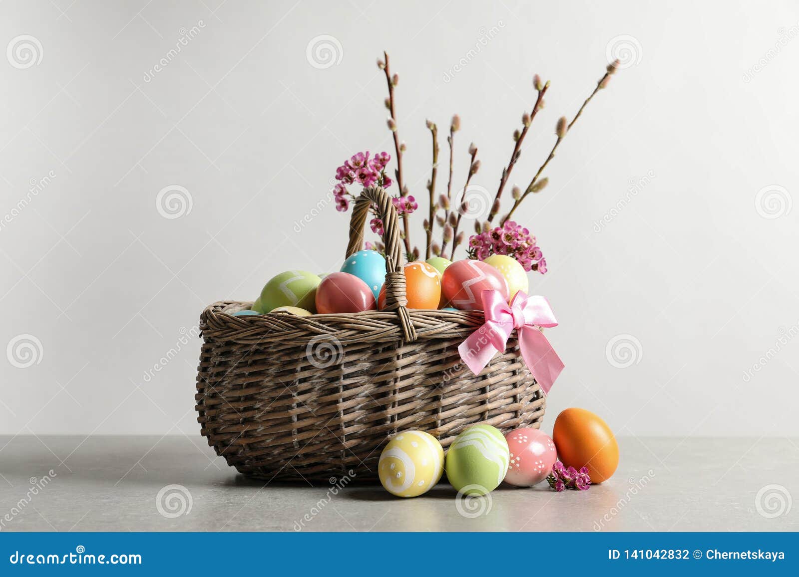 Wicker Basket with Painted Easter Eggs and Flowers Stock Photo Image