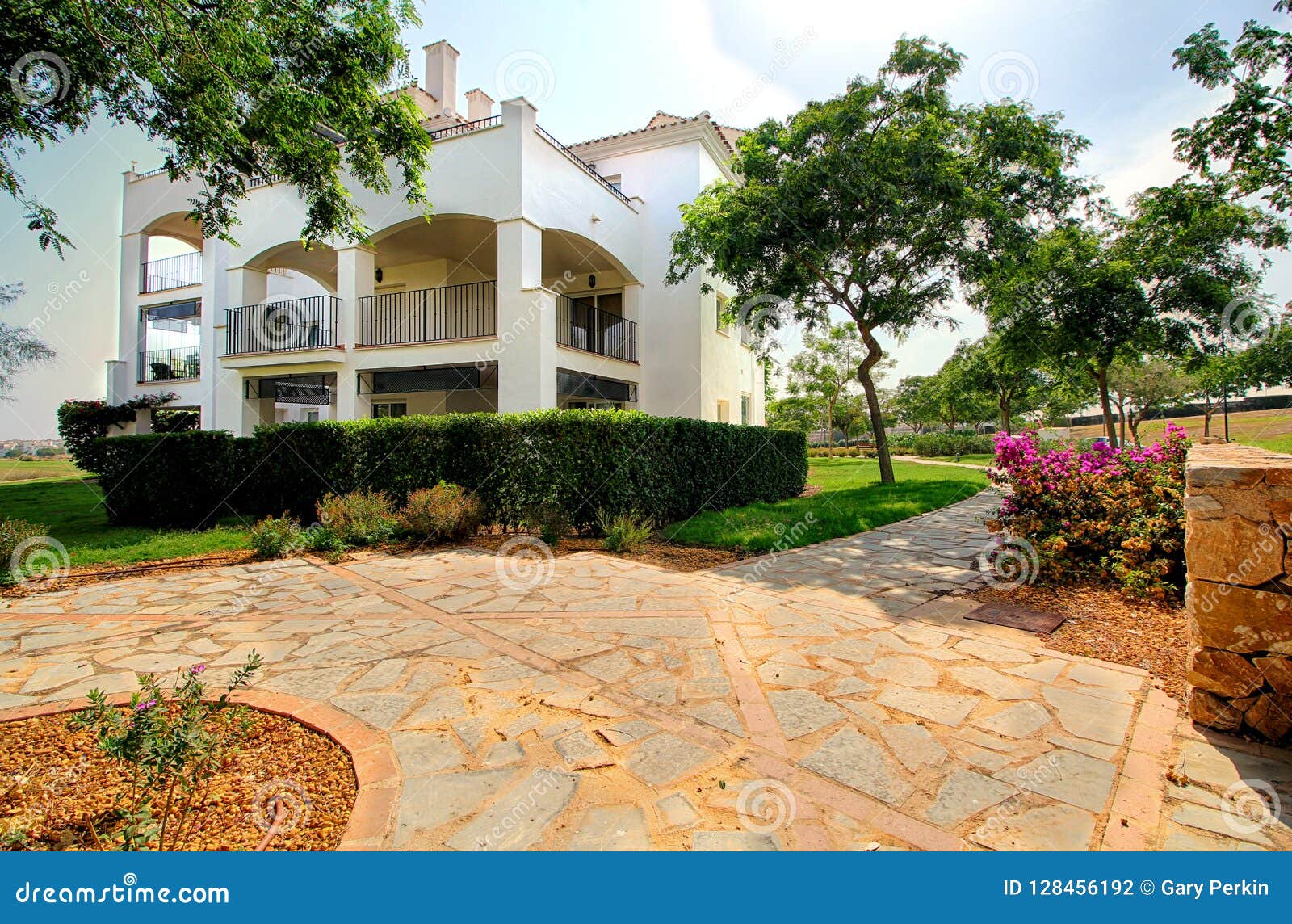 Wide Angle Shot Of Spanish Holiday Apartment Building In Beautiful