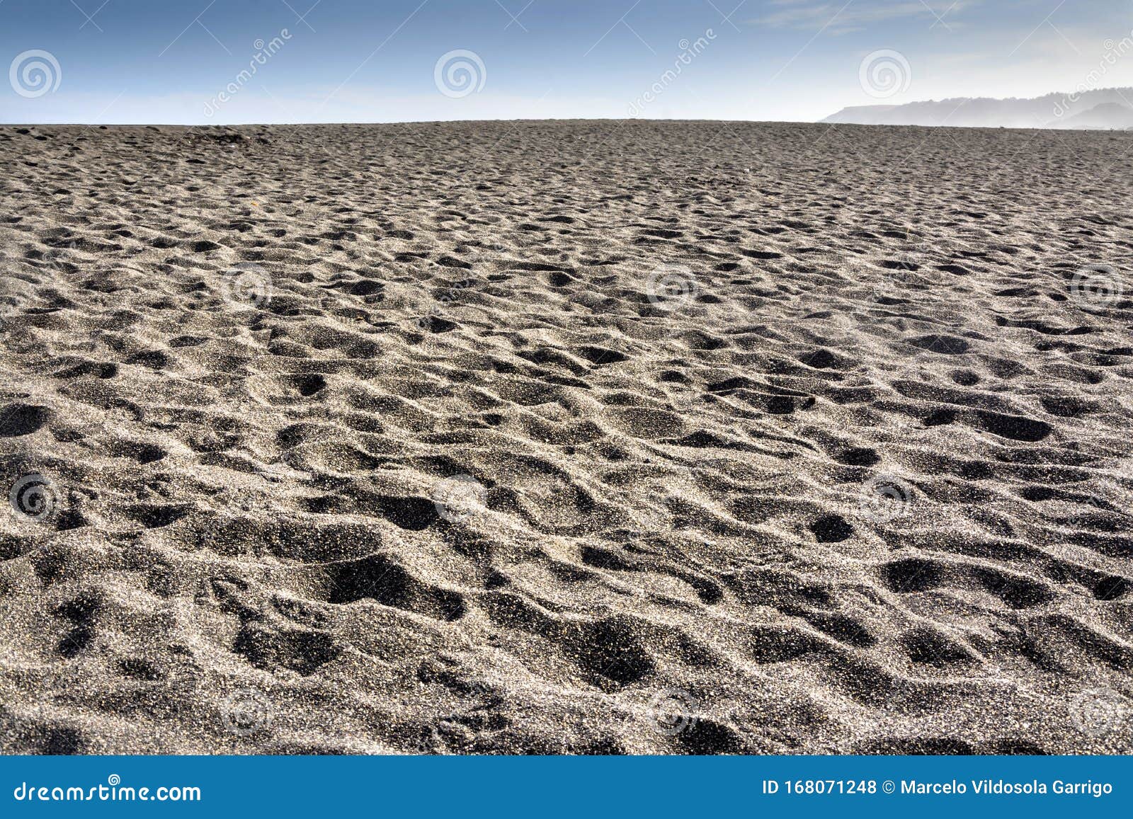 dark sand beach on the coast of cobquecura, chile.