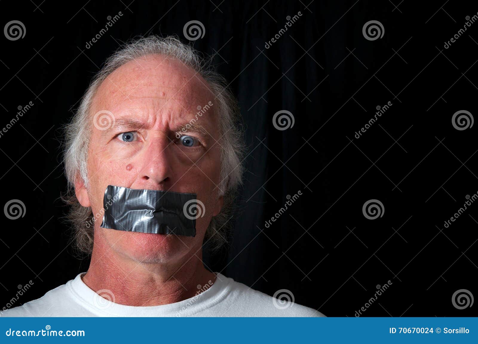 wide eyed man with duct taped mouth