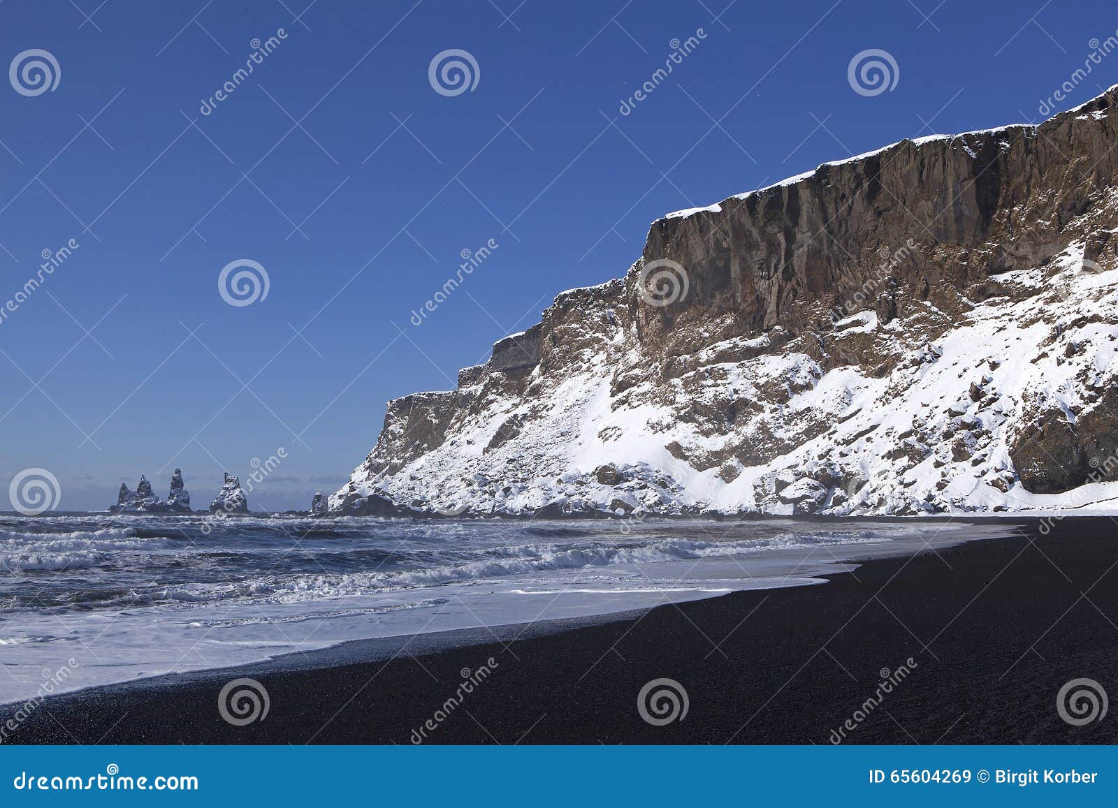 wide lens capture of the three pinnacles of vik, iceland in wintertime