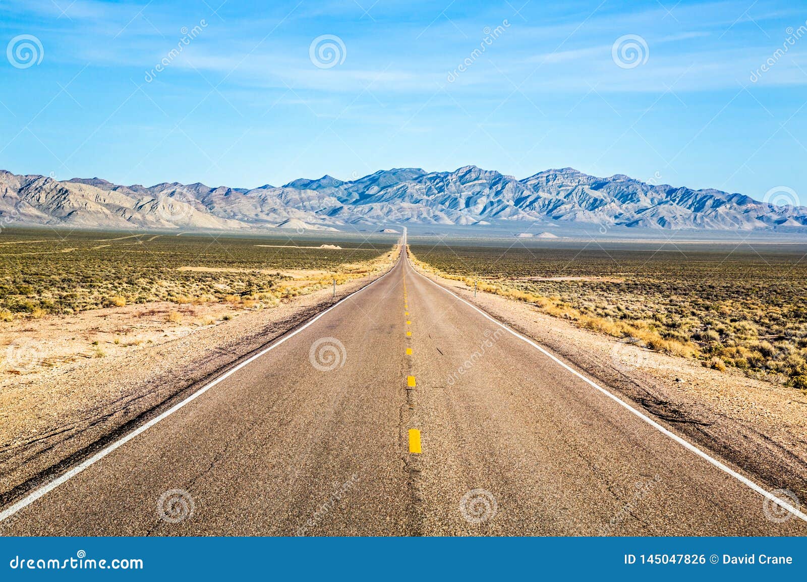 Wide Open Road and Distant Mountains in Wide Open Nevada Desert Along ...