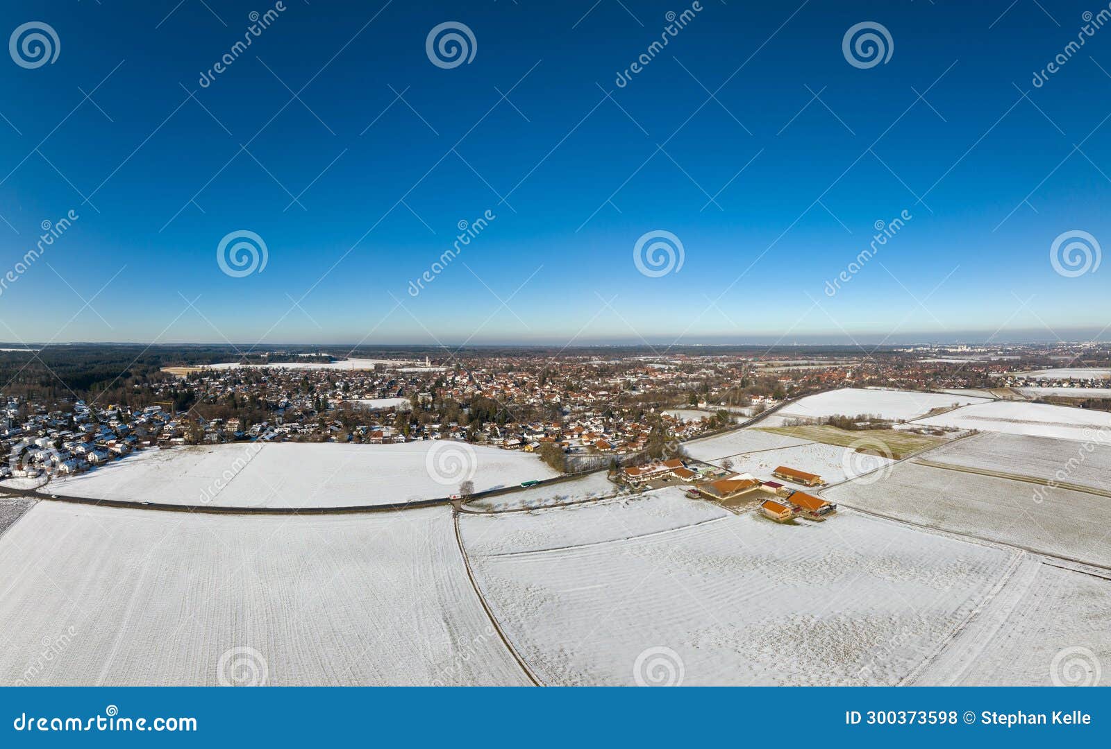Wide Panoramic View of a Winter Landscape with Snow White Fields and a