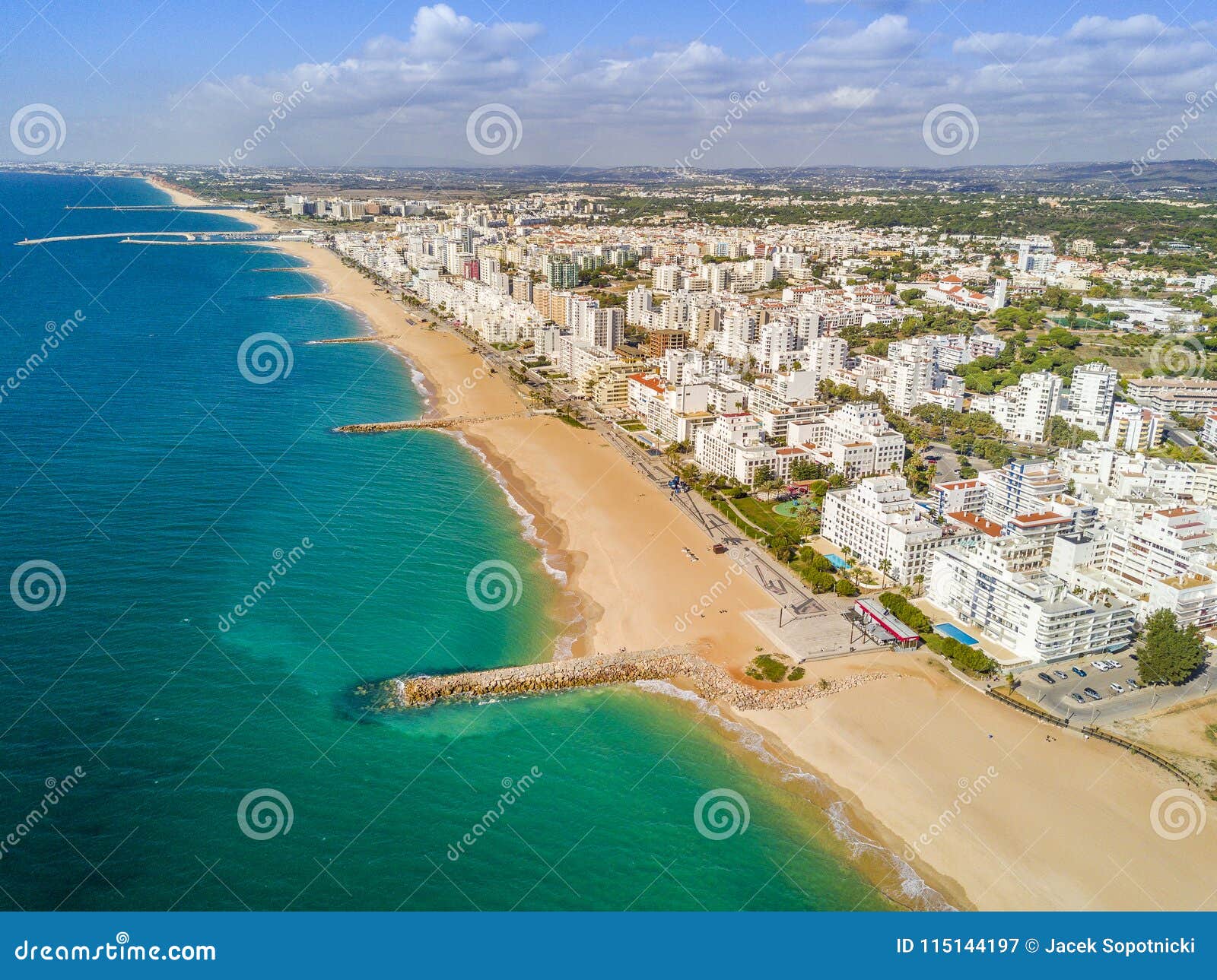 wide sandy beach in touristic quarteira and vilamoura, algarve,