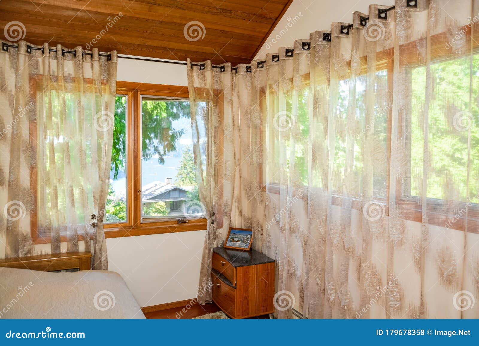 Wide Windows And Curtains In Small Bedroom With Ocean Bay View Wide Windows And Curtains In Small Bedroom With Ocean Bay View