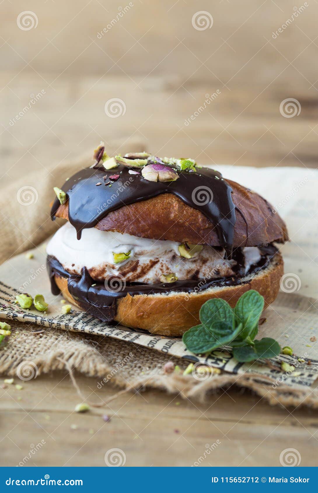wierd burger with vanilla ice cream and chocolated confetti on wooden background.