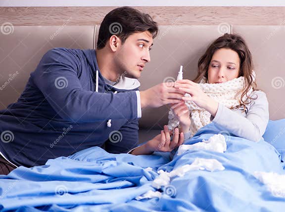 Wife Caring For Sick Husband At Home In Bed Stock Image Image Of