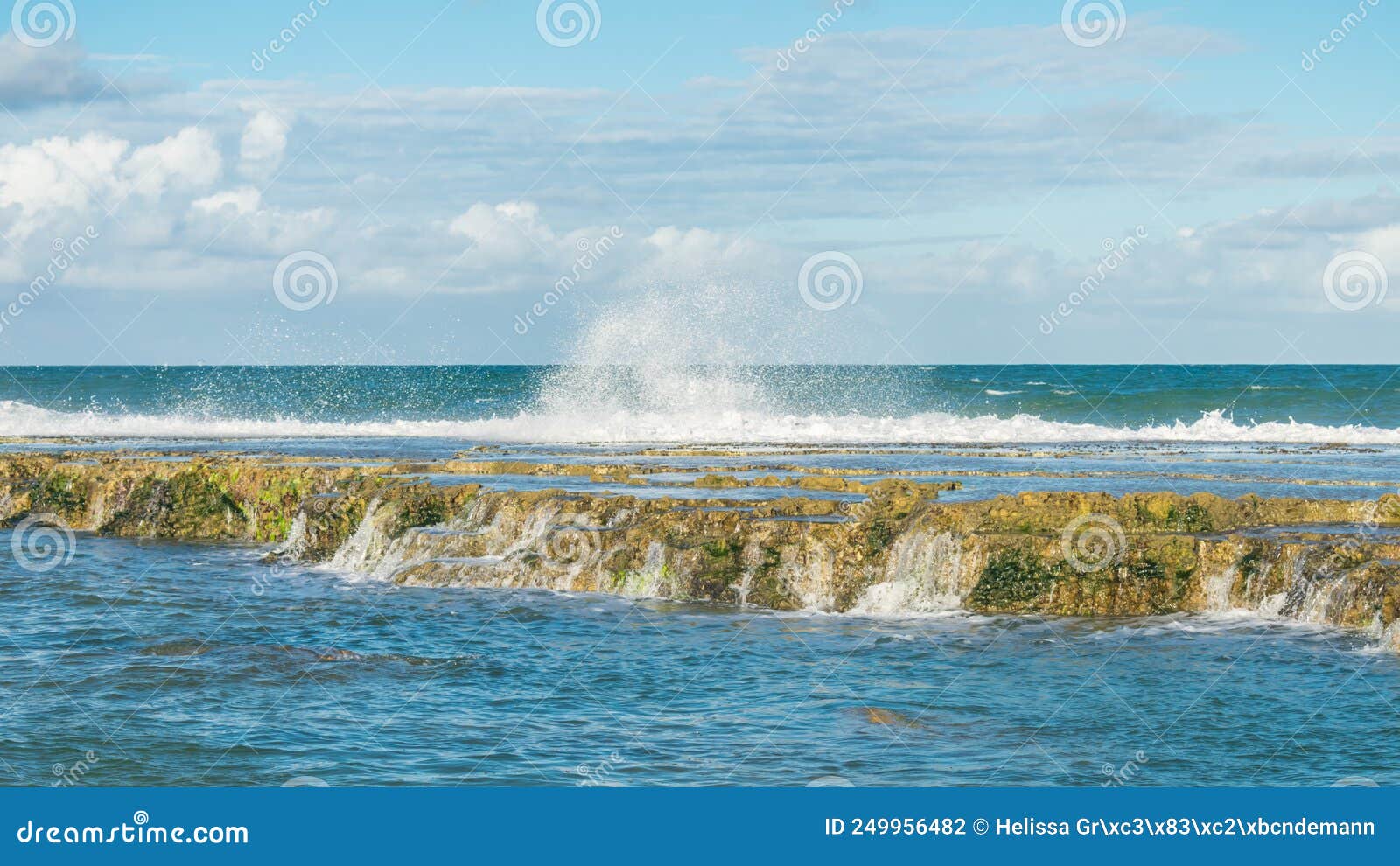 wild waves crashing on the rocky reef at the beach in aremebe - bahia, brazil