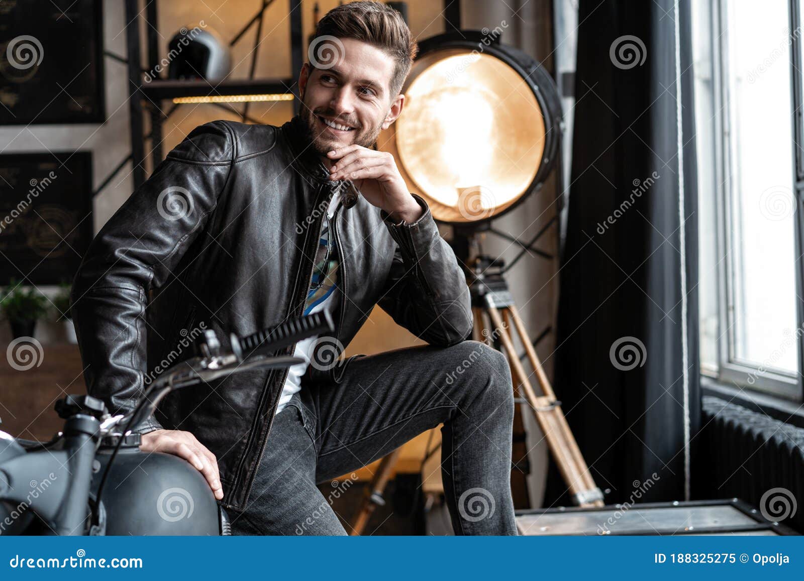 Handsome Young Man in Leather Jacket Looking Away while Sitting on the ...