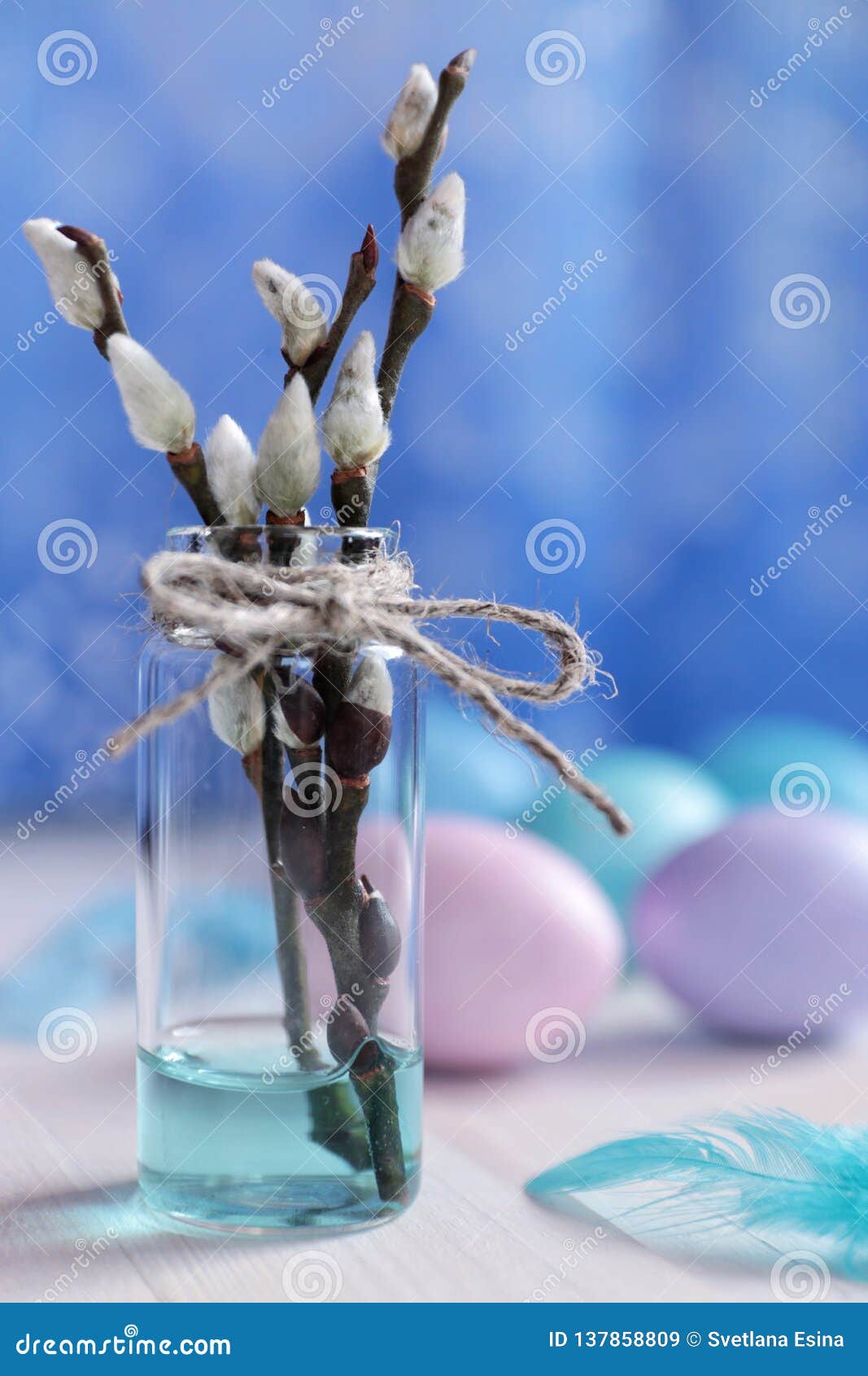 Willow Branches in Glass Vase and Colored Eggs for Easter Stock Image