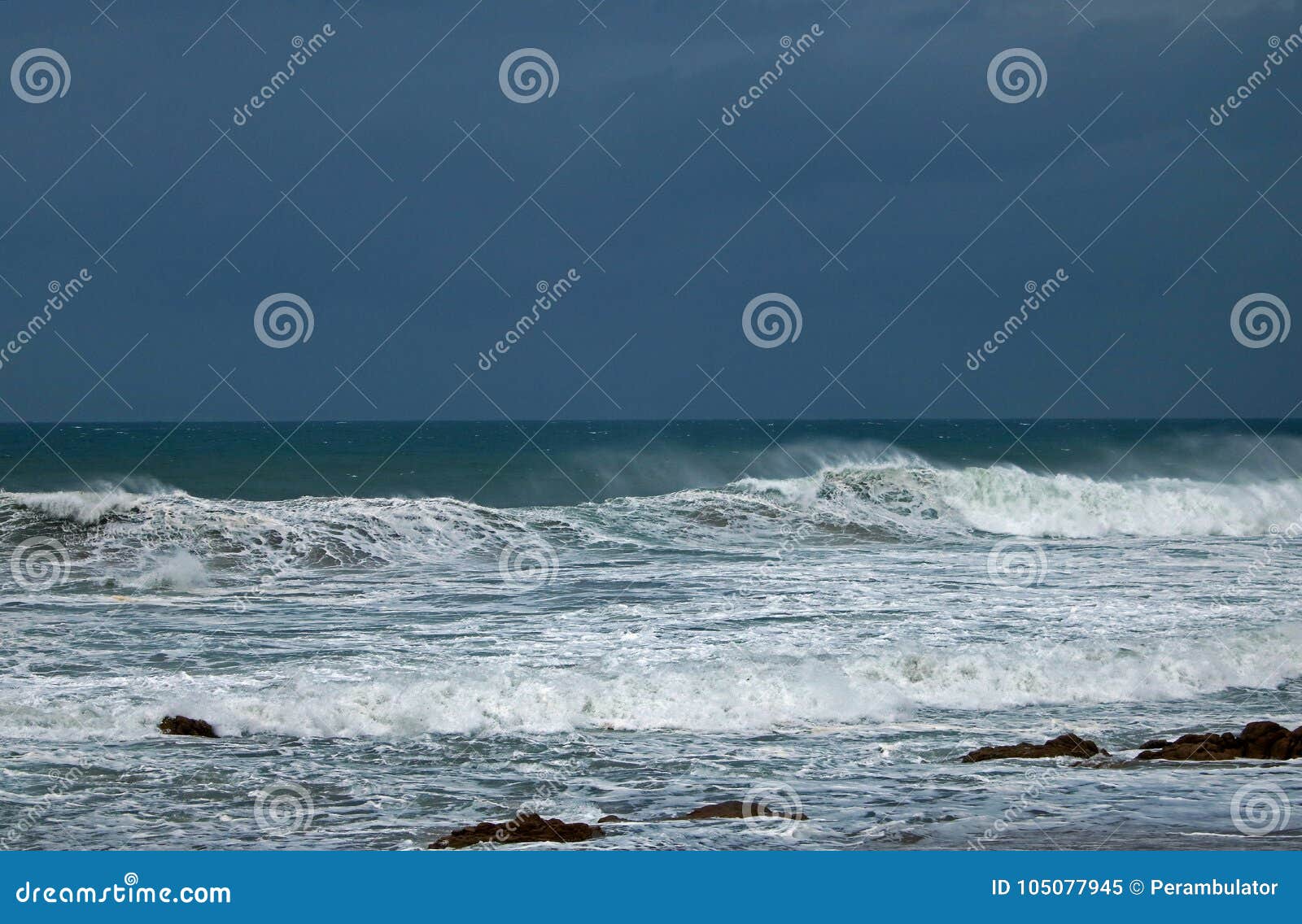 WIND BLOWING SPRAY from the SURF on a WAVE in the OCEAN. Stock Image