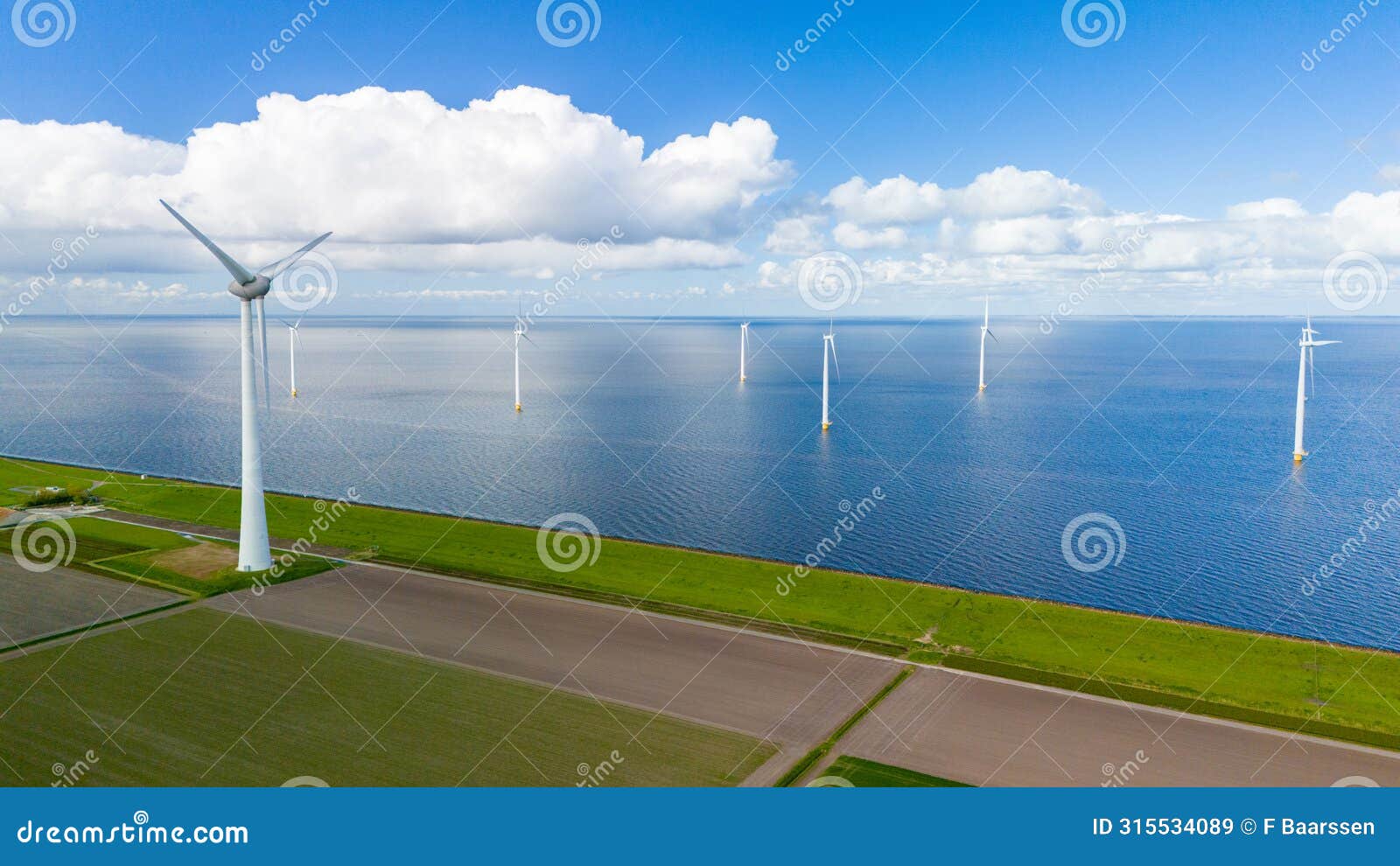 a wind farm filled with turbines rises from the choppy waters of the netherlands, harnessing the power of the wind to