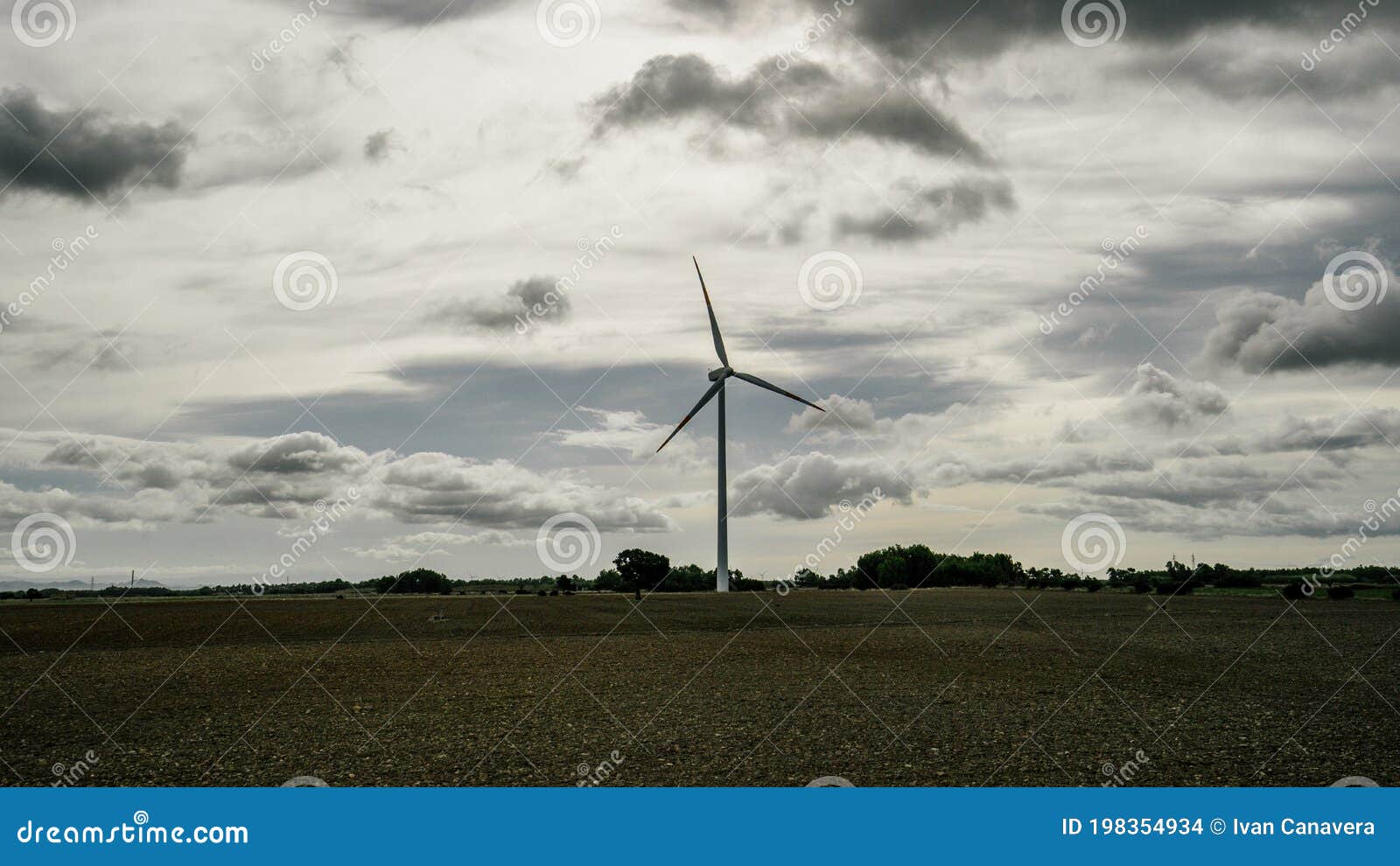 wind turbine with a cloudy and gray sky