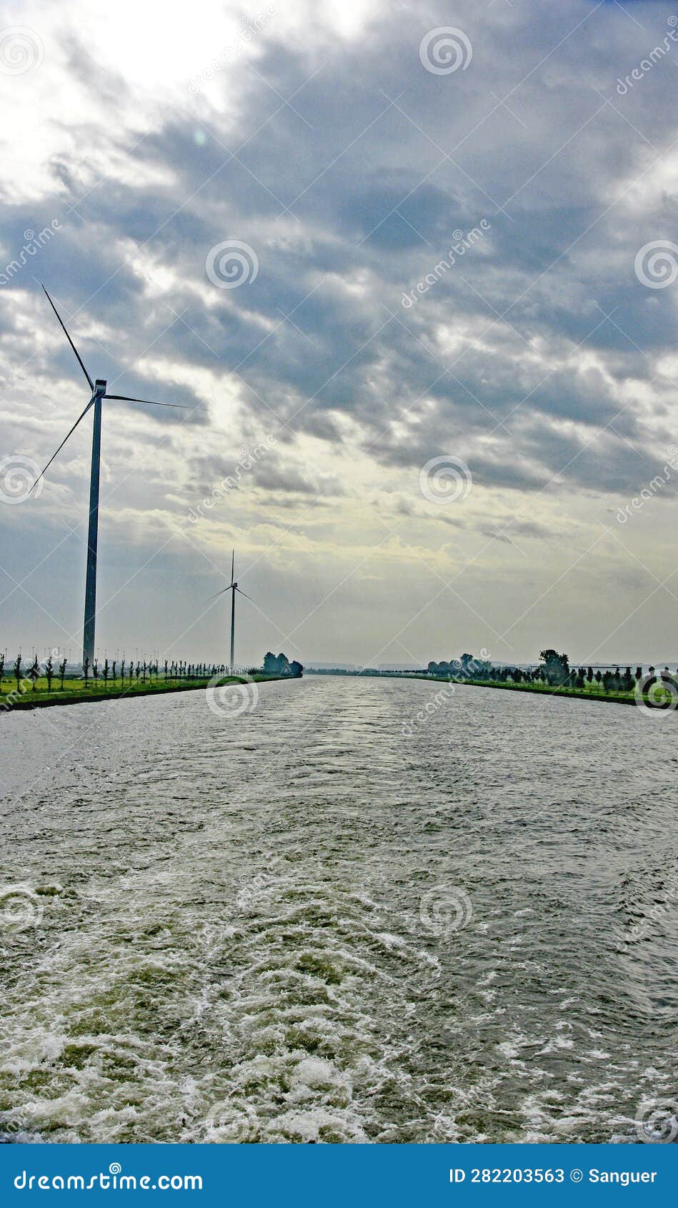 wind turbines on the banks of the rhine river in holland