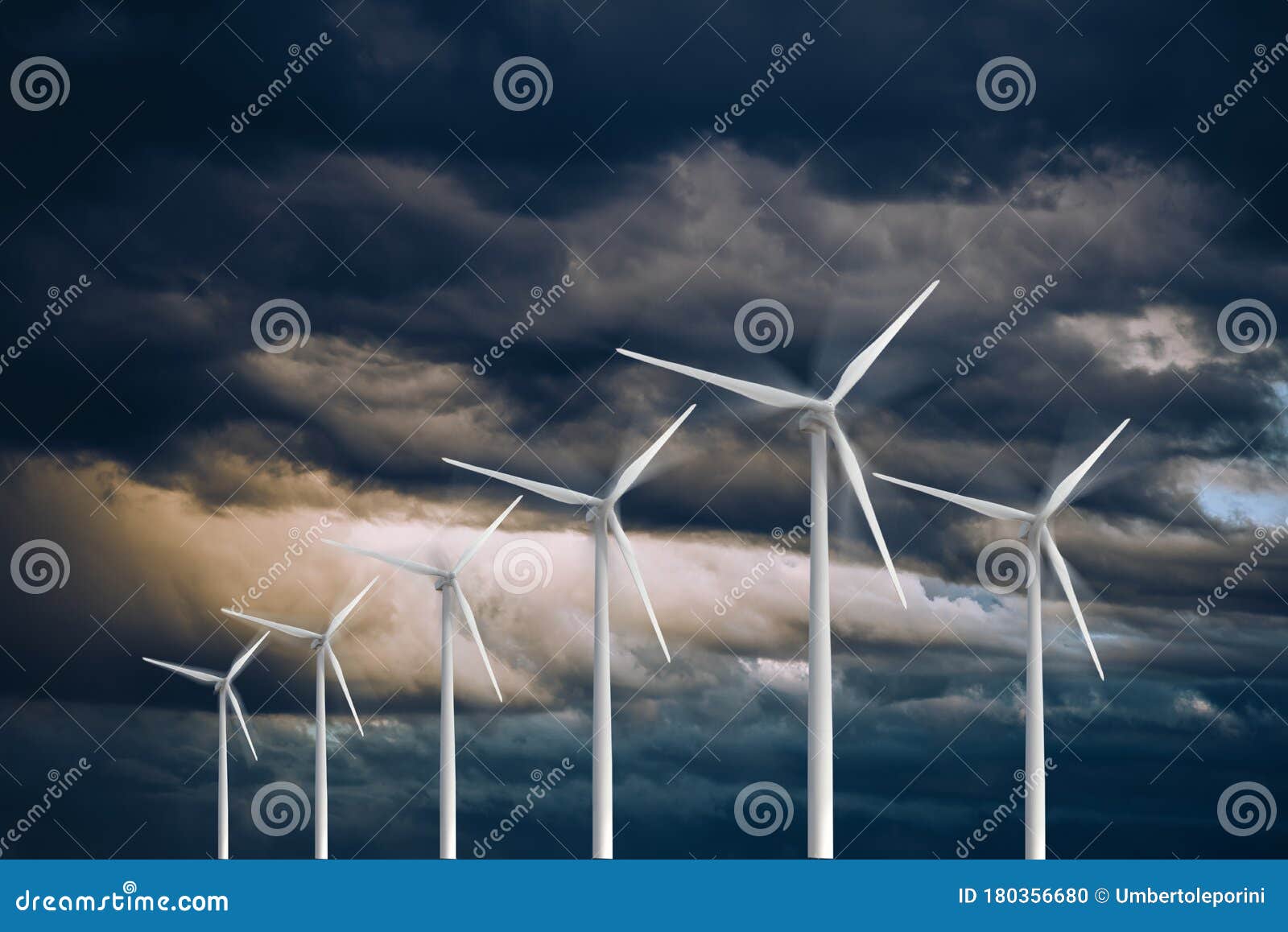 wind turbines power generators on a stormy dramatic sky renewable and sustainable energy concept