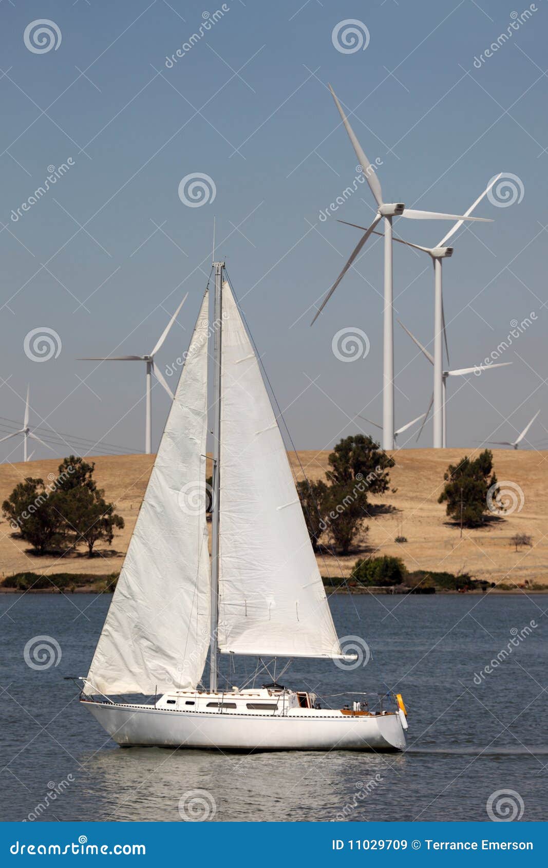 Wind Turbines and Sailboat stock image. Image of energy 11029709