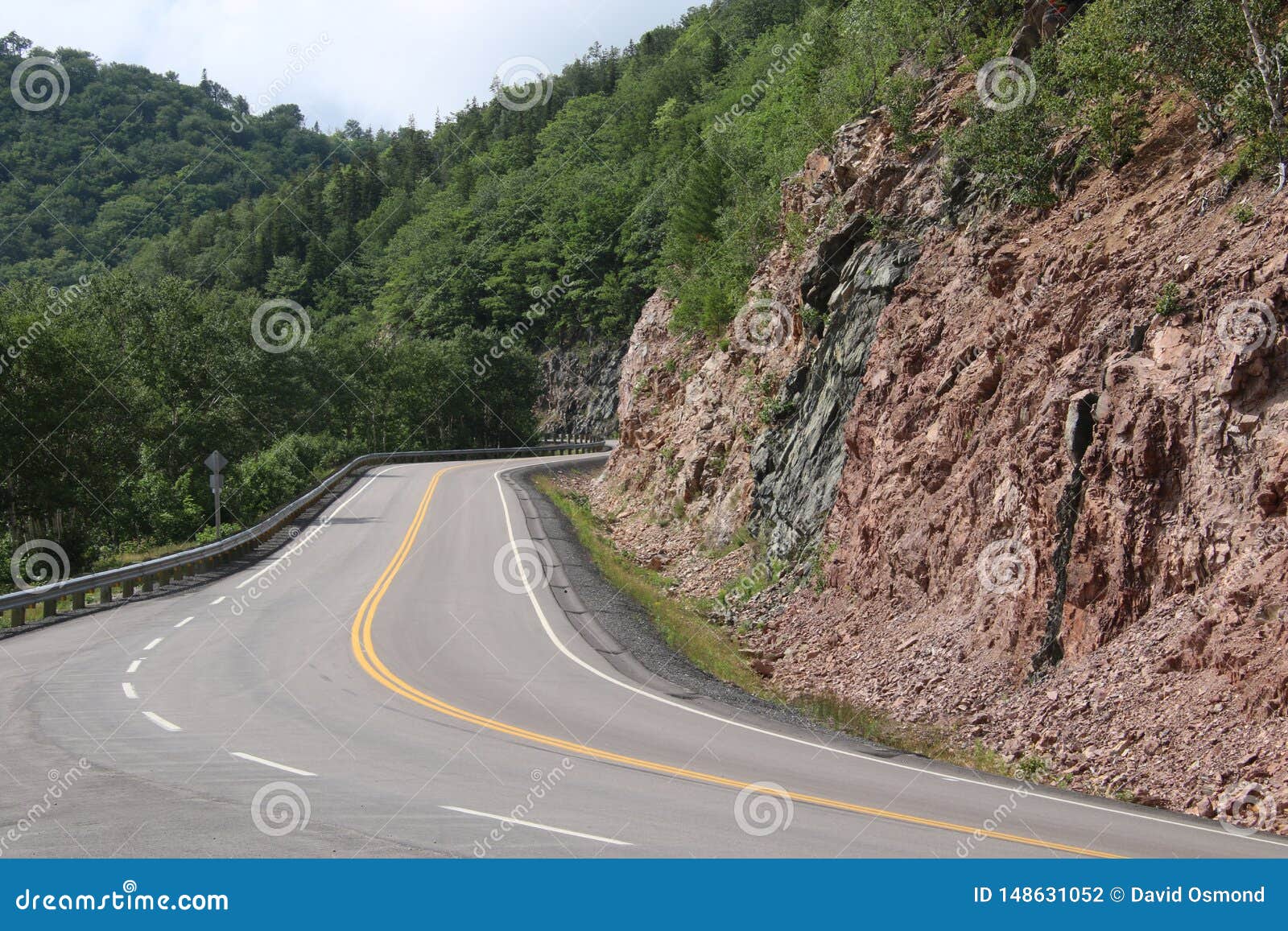 A Winding Road with a Rock Cliff on the Right Stock Photo Image of